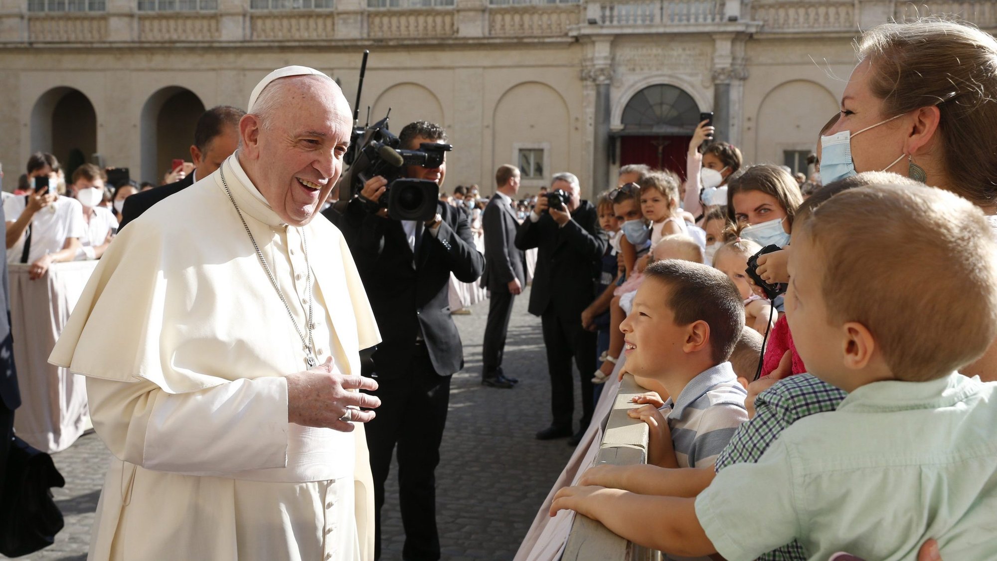 Pope Francis greets family members as he arrives to lead his general audience in the San Damaso courtyard at the Vatican Sept. 9, 2020. The pope spoke with the family and gave them a blessing in English. (CNS photo/Paul Haring)