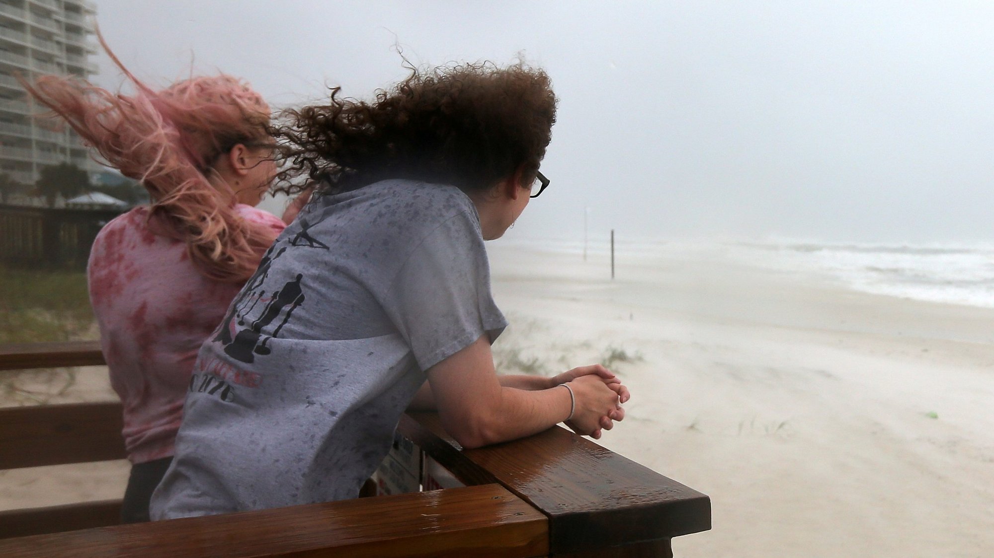 Women in Orange Beach, Ala., watch waves come ashore Sept. 15, 2020, as Hurricane Sally approaches the area. (CNS photo/Jonathan Bachman, Reuters)