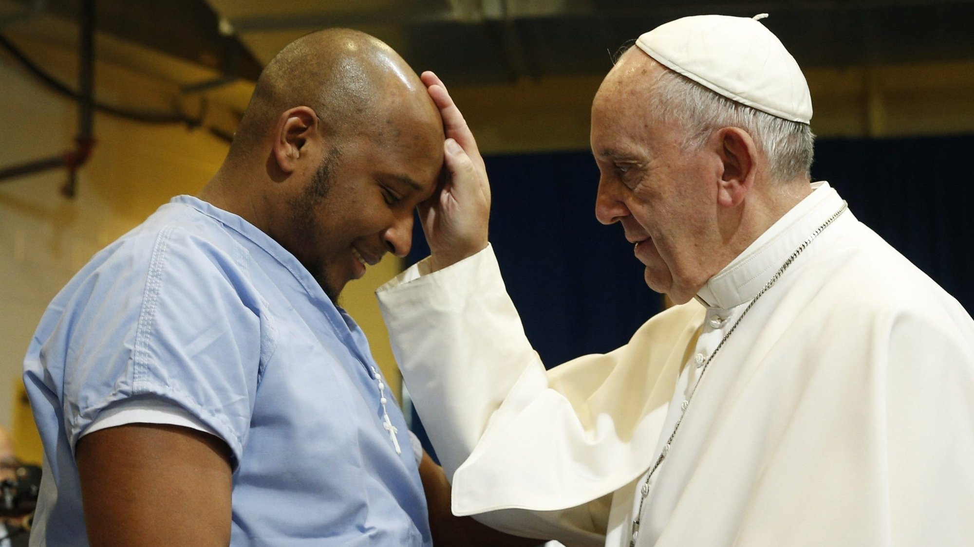 Pope Francis blesses a prisoner as he visits the Curran-Fromhold Correctional Facility in Philadelphia in this Sept. 27, 2015, file photo. The pope has chosen the theme, "Come and see: Communicating, encountering people as and where they are," for the 2021 World Communications Day. (CNS photo/Paul Haring)