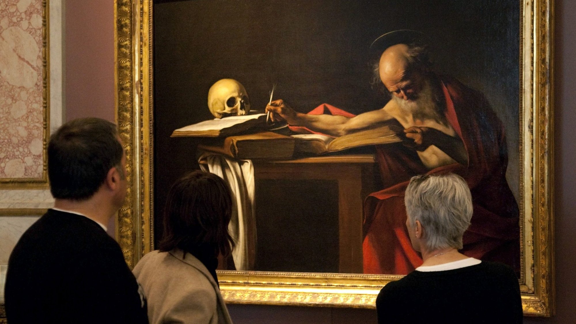 Visitors are pictured in a file photo looking at a Caravaggio painting titled "St. Jerome Writing" during an exhibition at the Galleria Borghese in Rome. Pope Francis released "Scripturae Sacrae affectus" ("Devotion to Sacred Scripture"), a new apostolic letter on the Bible, Sept. 30, 2020, coinciding with the 1,600th anniversary of St. Jerome's death. (CNS photo/Max Rossi, Reuters)
