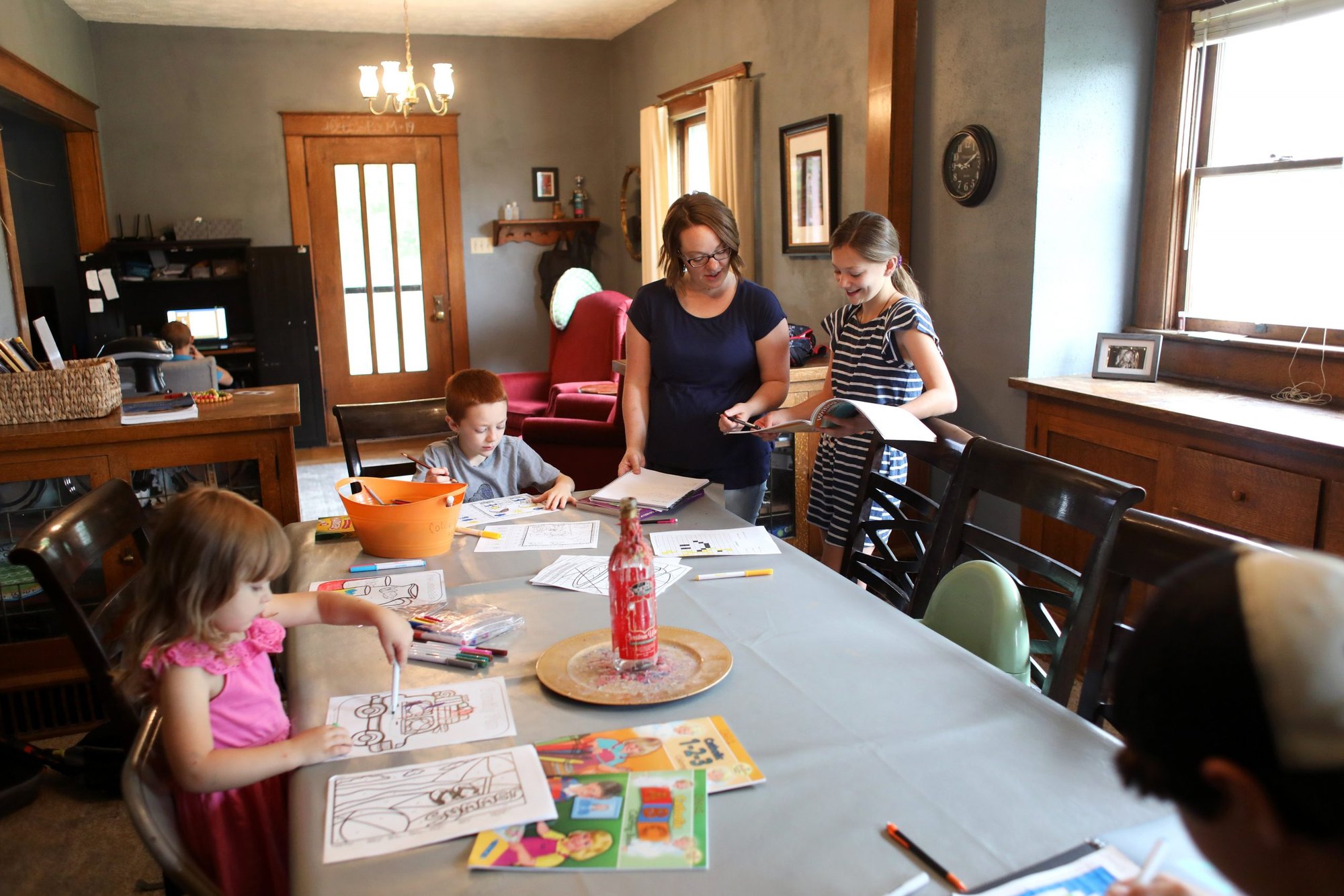Amanda Ring of Beloit, Kan., talks with her daughter, Bella, about a homeschool assignment July 29, 2020. Ring takes turns working with each of her seven children. (CNS photo/Karen Bonar, The Register)