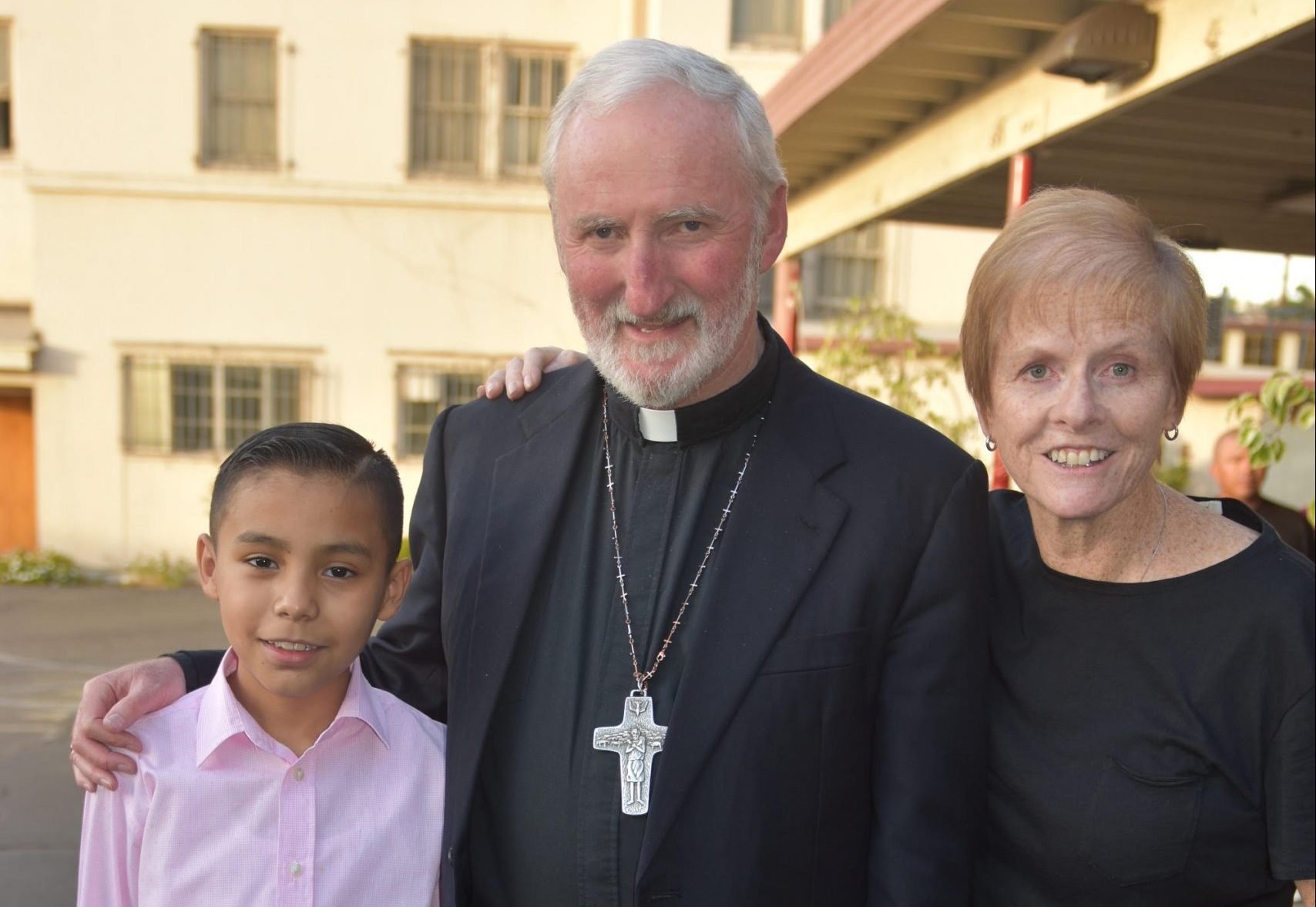 Linda Dakin-Grimm with Auxiliary Bishop David O'Connell and "Adán," who came to LA from El Salvador as an unaccompanied minor. (Gary Grimm)