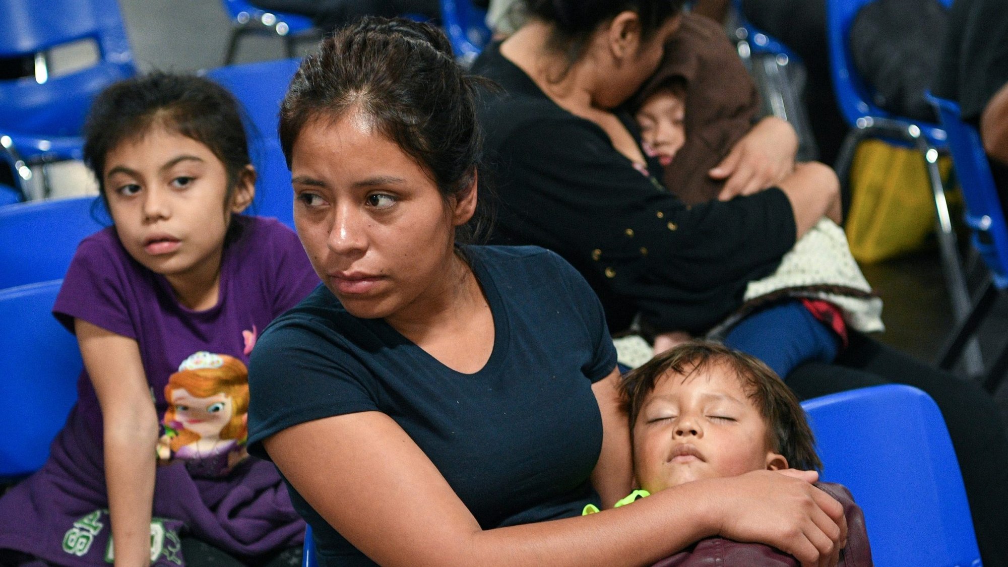 A Honduran migrant mother recently released from federal detention with fellow asylum seekers holds her sleeping three-year-old son July 29, 2019, at a new humanitarian respite center run by Catholic Charities of the Rio Grande Valley in McAllen, Texas. (CNS photo/Loren Elliott, Reuters)