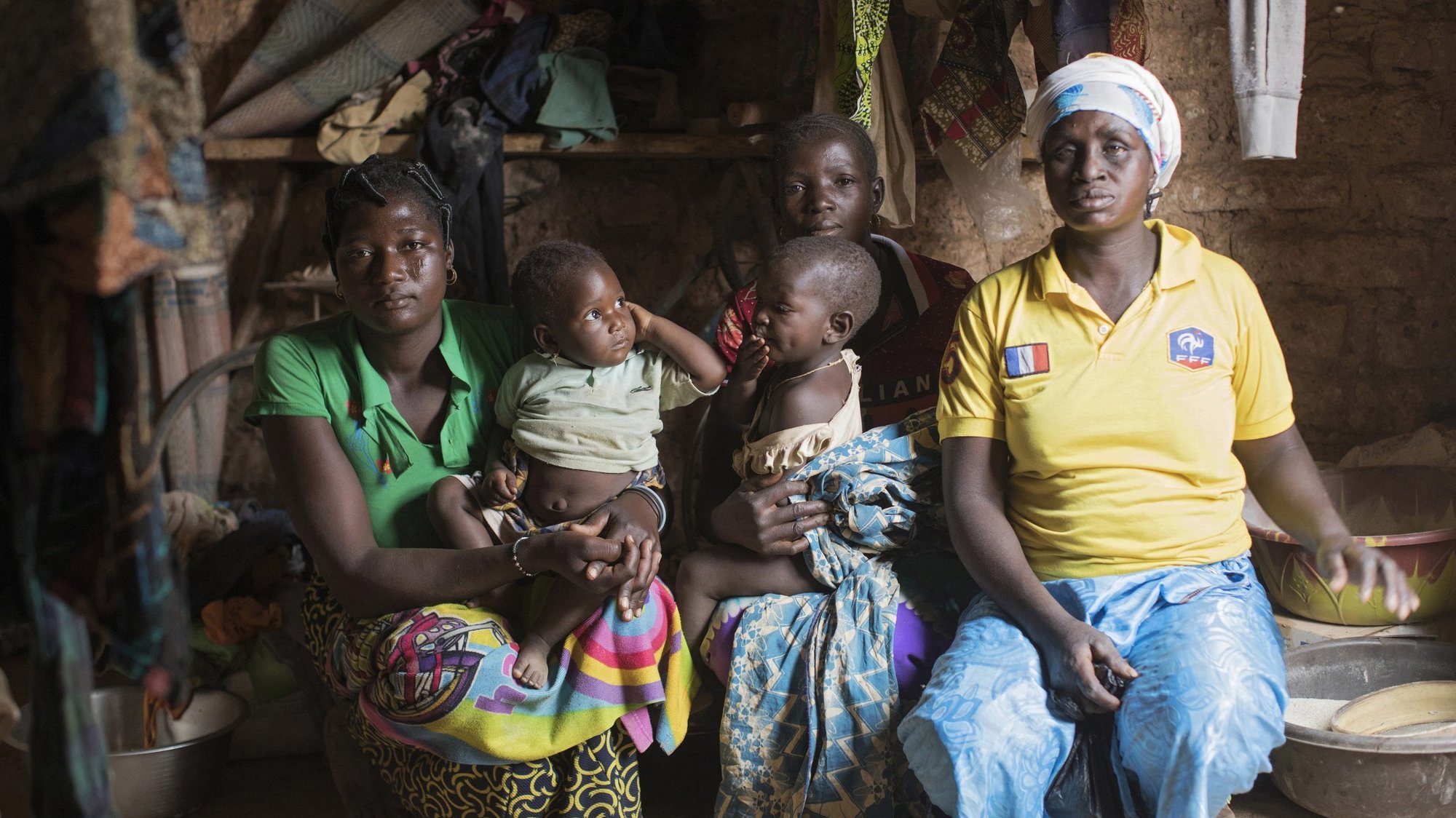 A family poses for a photo in mid-March in their home in Kaya, Burkina Faso. Most people in the Sahel region in Africa are poor and lack formal education and skills "that could enable them to ascend social and economic ladders," a report from Catholic Relief Services said. (CNS photo/Julien Ermine, Reuters)