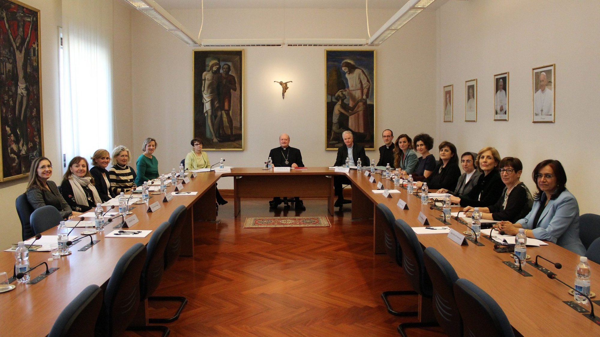 Cardinal Gianfranco Ravasi, center, and Bishop Paul Tighe pose at a 2019 meeting of the Women's Consultation Group at the Vatican. The 20 members of the group, Catholics, other Christians and members of other faiths, met online Oct. 7 for a webinar reflecting together on Pope Francis' 2013 exhortation, "The Joy of the Gospel." (CNS photo/courtesy Pontifical Council for Culture)