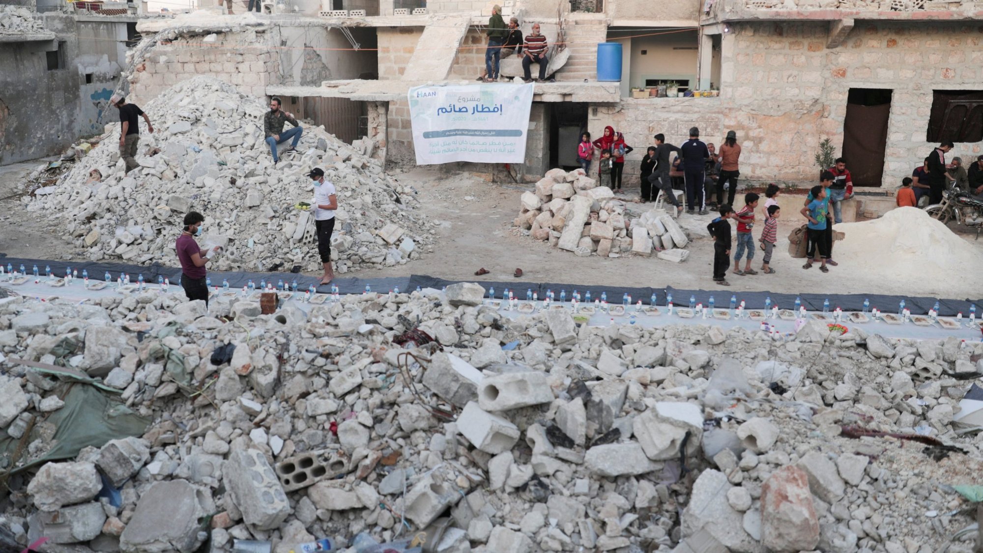 Volunteers are seen in early May preparing meals in a damaged neighborhood in Aleppo, Syria. Ambassadors to the Vatican from around the world were called together Oct. 15, 2020, to hear from Cardinal Mario Zenari, apostolic nuncio to Syria, about the humanitarian disaster in Syria. (CNS photo/Khalil Ashawi, Reuters)