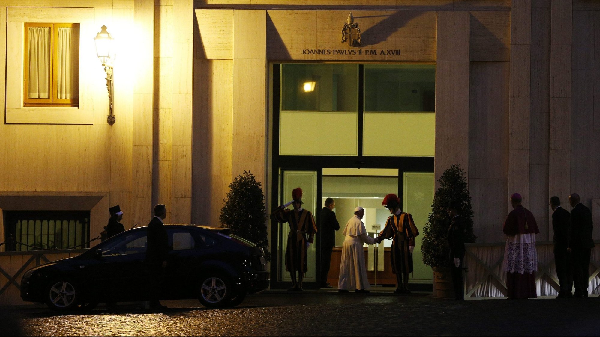 Pope Francis greets a Swiss Guard as he returns to his residence, the Domus Sanctae Marthae, after a service in St. Peter's Basilica at the Vatican in this Oct. 24, 2013, file photo. The Vatican announced Oct. 17 that a resident of the Domus Sanctae Marthae tested positive for COVID-19. (CNS photo/Paul Haring)