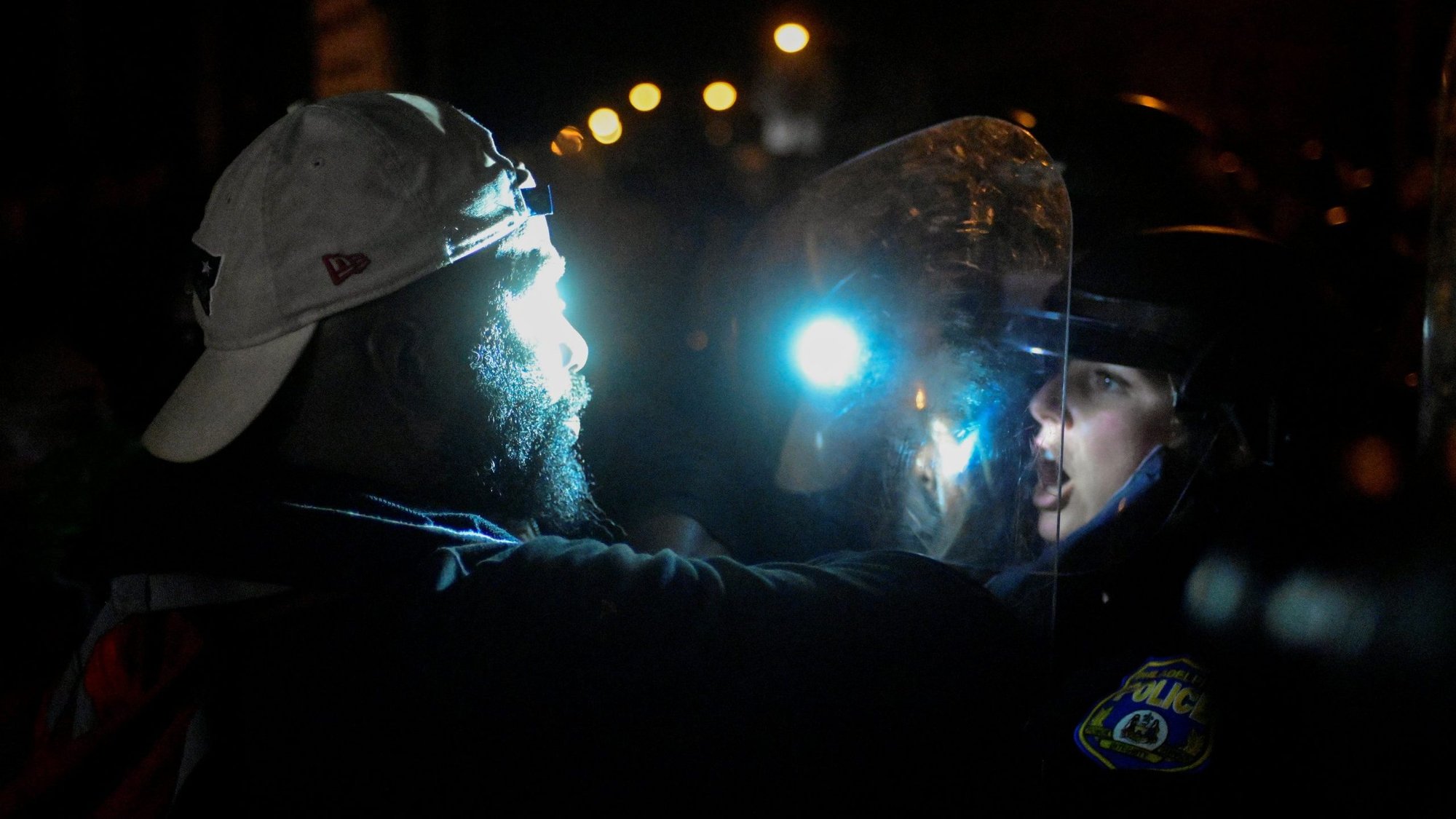 A demonstrator in Philadelphia confronts a police officer outside the 18th District Police station Oct. 27, 2020, after the death of Walter Wallace Jr., a Black man who was shot and killed by police when he approached them with a knife. News reports said the fatal shooting happened after the third call police made that day to Wallace's house for a domestic disturbance. (CNS photo/Bastiaan Slabbers, Reuters)