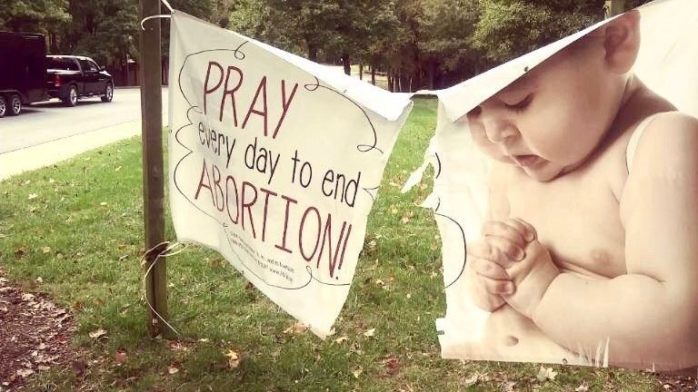 A pro-life sign is seen damaged in front of St. Vincent de Paul Church in Charlotte, N.C., in this undated photo. (CNS photo/courtesy Diocese of Charlotte)