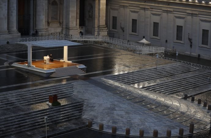 In this photo taken on March 27, 2020, Pope Francis, figure in white standing alone at center, delivers an Urbi et orbi prayer from the empty St. Peter's Square, at the Vatican. (Yara Nardi/Pool Photo via AP)