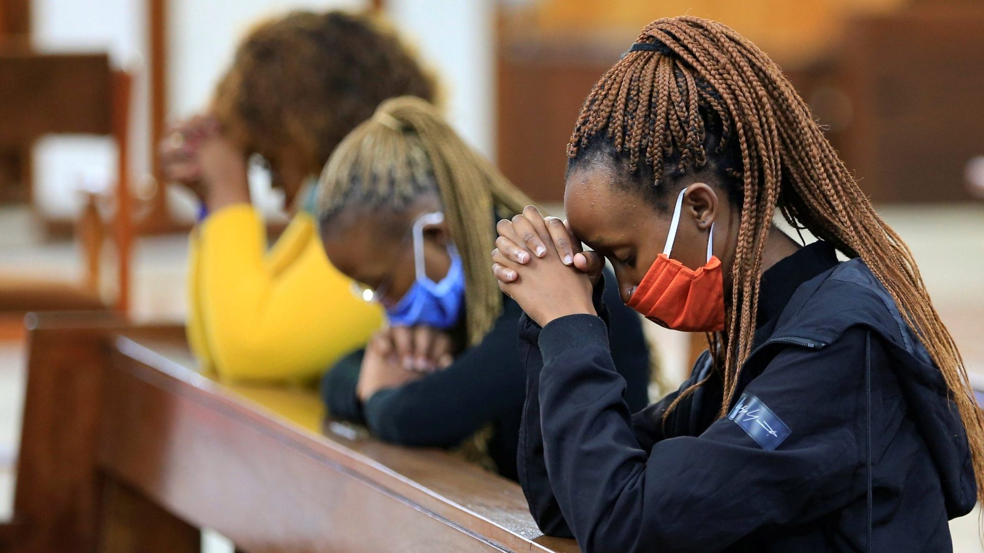 A women wearing a protective masks pray during Mass in late July at the Cathedral Basilica of the Holy Family in Nairobi, Kenya, during the COVID-19 pandemic. (CNS Photo/Thomas Mukoya, Reuters)