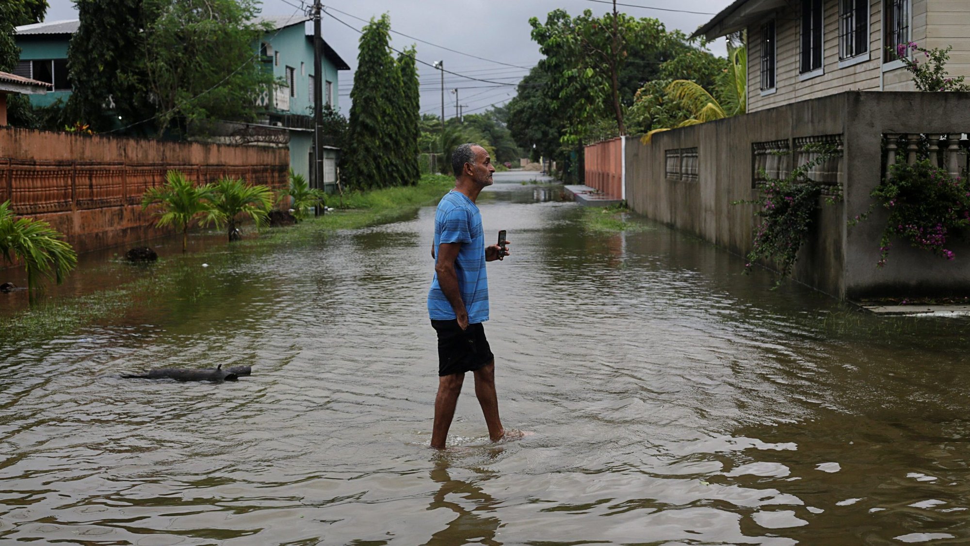 A resident walks through a flooded street as Hurricane Eta approaches Tela, Honduras, Nov. 3, 2020. (CNS photo/Jorge Cabrera, Reuters)