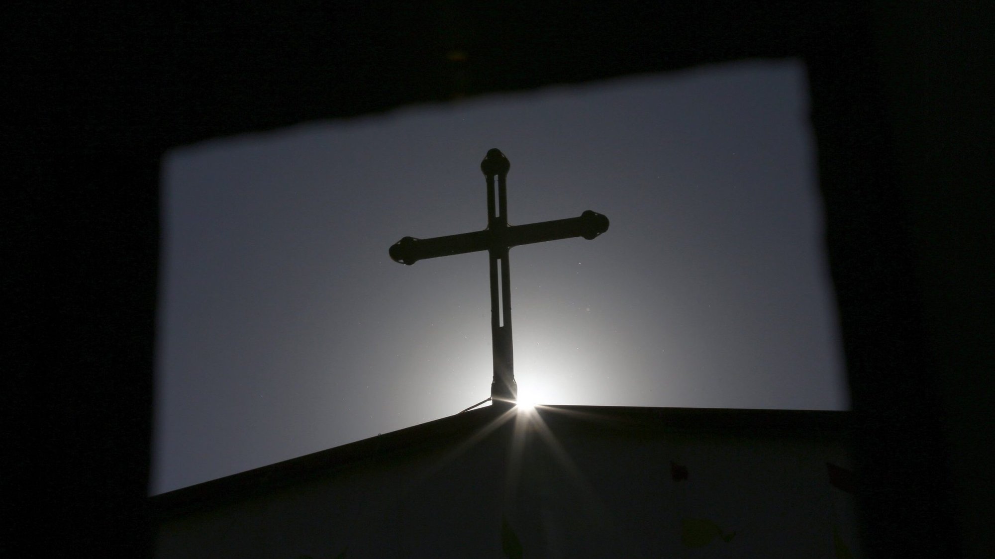 A cross atop a Catholic church is silhouetted in Tianjin, China. (CNS photo/Kim Kyung-Hoon, Reuters)