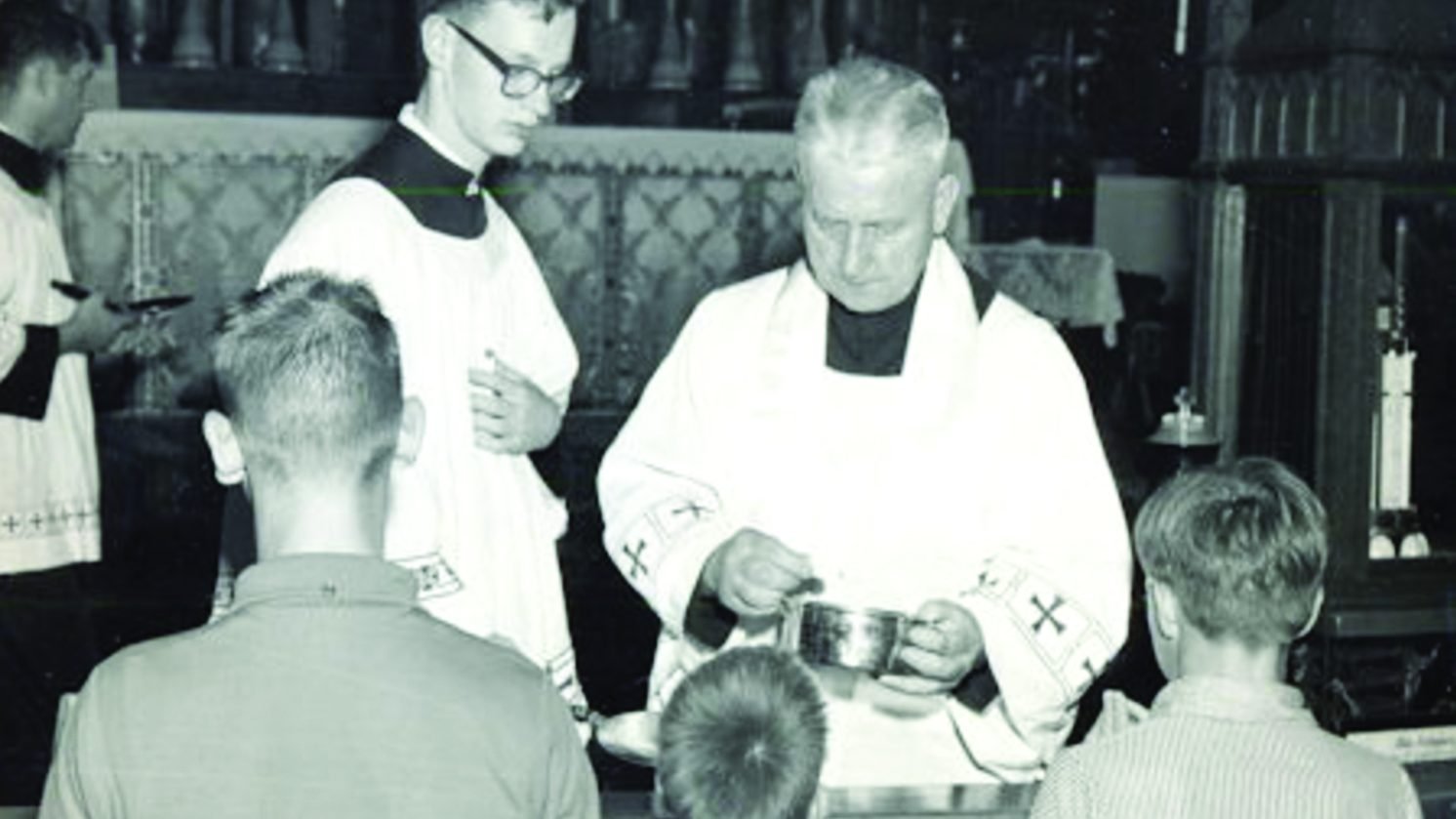 Father Ciszek distributes Communion at Mass in the late 1960s. (© The Father Walter Ciszek Prayer League)