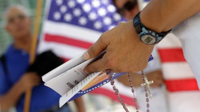 Hispanics pray outside the Sandra Day O'Connor Courthouse in Phoenix in this illustration photo. (CNS/Joshua Lott, Reuters via Crux)