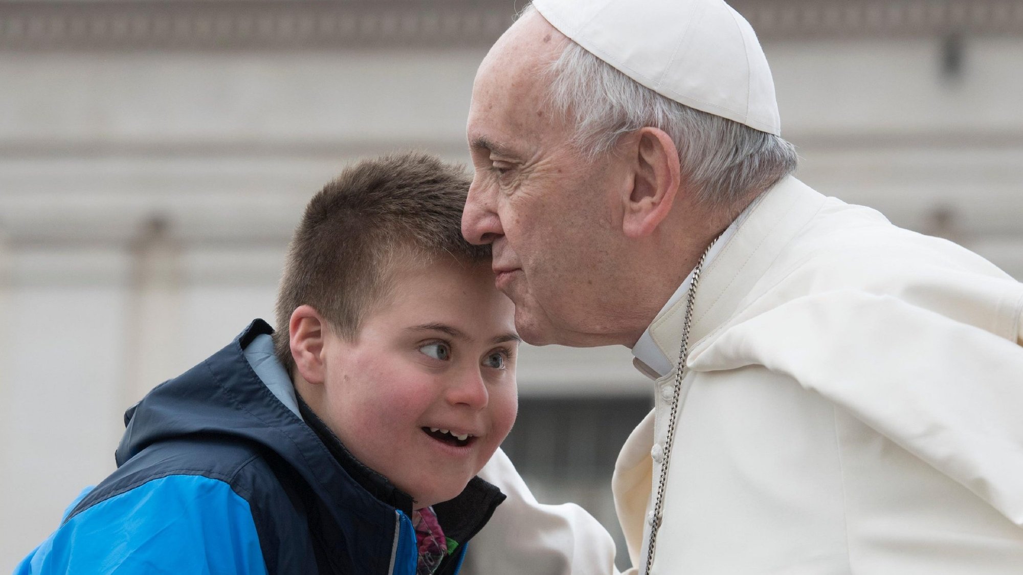 Pope Francis kisses Peter Lombardi, 12, of Columbus, Ohio, who has Down syndrome, after the boy rode in the popemobile during his general audience in St. Peter's Square at the Vatican March 28, 2018. (CNS photo/Vatican Media)