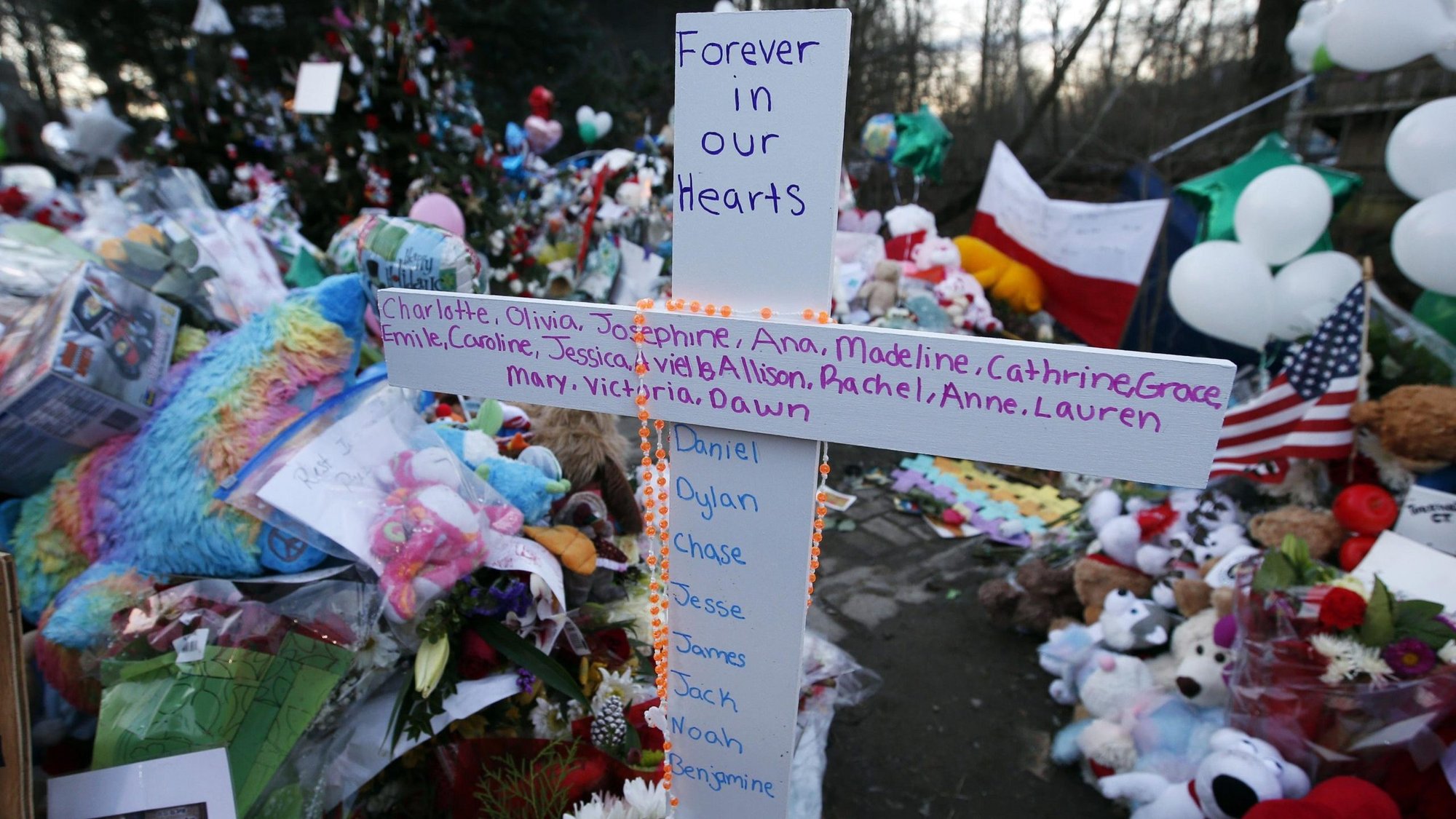 A cross bearing the first names of the victims of the Dec. 14, 2012, shootings at Sandy Hook Elementary School is pictured amid hundreds of other items left by mourners at a memorial in Newtown, Conn., Dec. 19, 2012. People around the country were remembering the tragedy Dec. 14, 2020, the eighth anniversary of the shooting that left 20 children and six adults dead. (CNS photo/Mike Segar, Reuters)