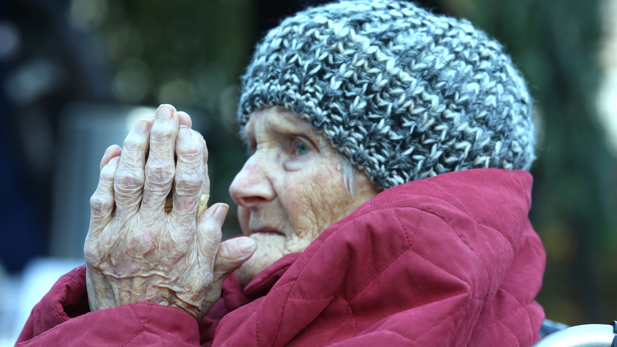A resident attends a Christmas party in the backyard of St. Martha retirement home in Speyer, Germany, Dec. 16, 2020, during the COVID-19 pandemic. (CNS photo/Ralph Orlowski, Reuters)