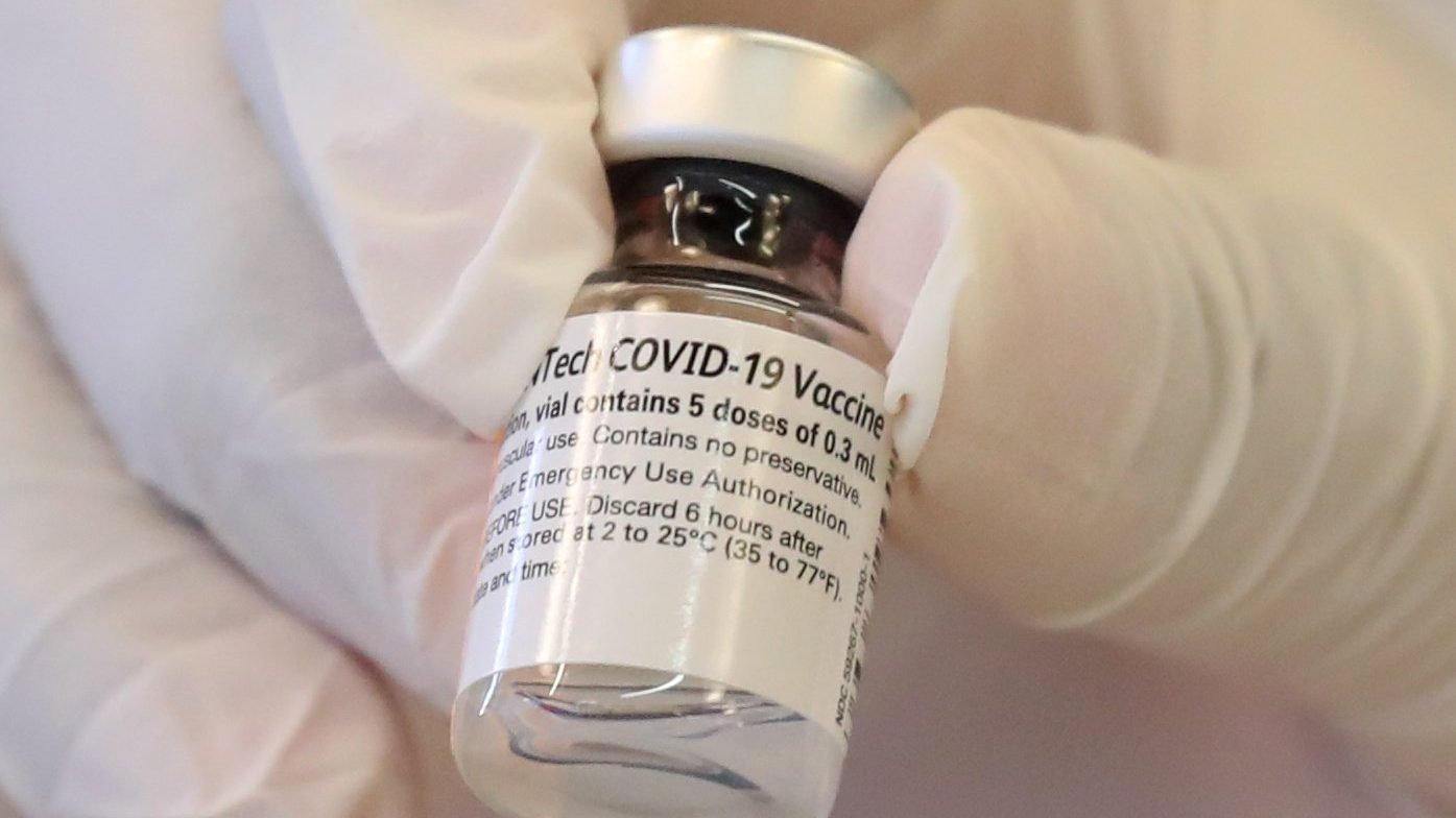 A health care worker at Martin Luther King Jr. Community Hospital in Los Angeles holds a vial of the COVID-19 vaccine Dec. 17, 2020. (CNS photo/Lucy Nicholson, Reuters)