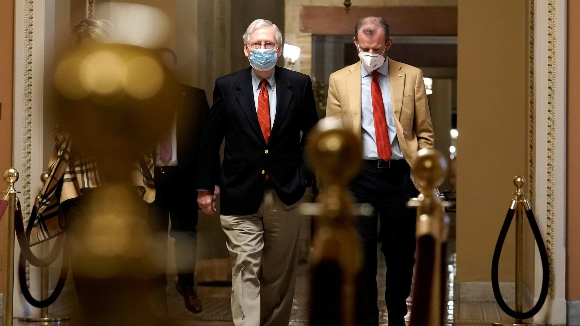 Senate Majority Leader Mitch McConnell, R-Ky., left, walks from his office to the Senate floor on Capitol Hill Washington Dec. 20, 2020. (CNS photo/Ken Cedeno, Reuters)