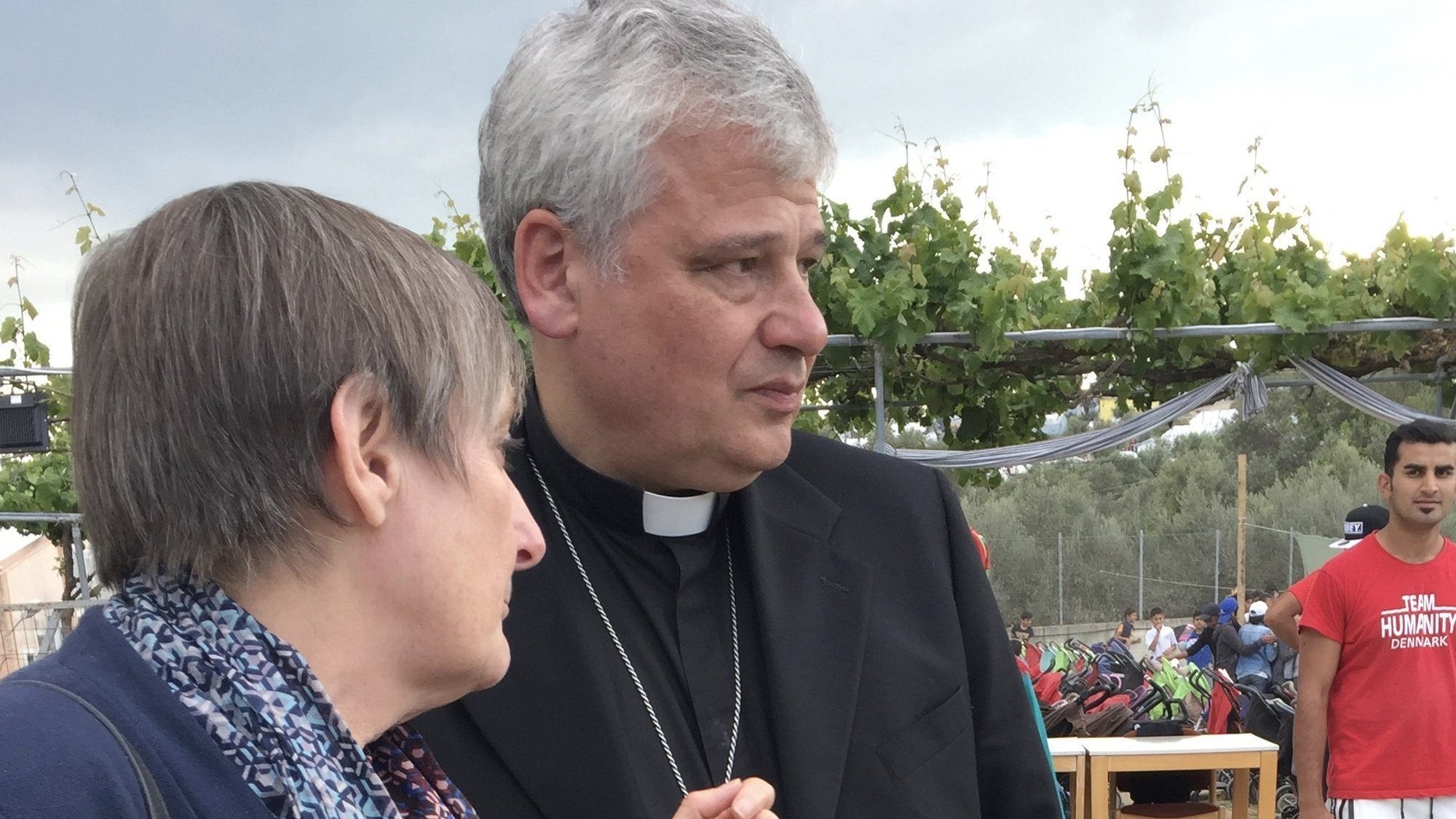 Daniela Pompei confers with Cardinal Konrad Krajewski, the papal almoner, during a May 2019 visit to the Moria refugee camp on the Greek island of Lesbos. The cardinal has tested positive for COVID-19 and is hospitalized. (CNS photo/Cindy Wooden)