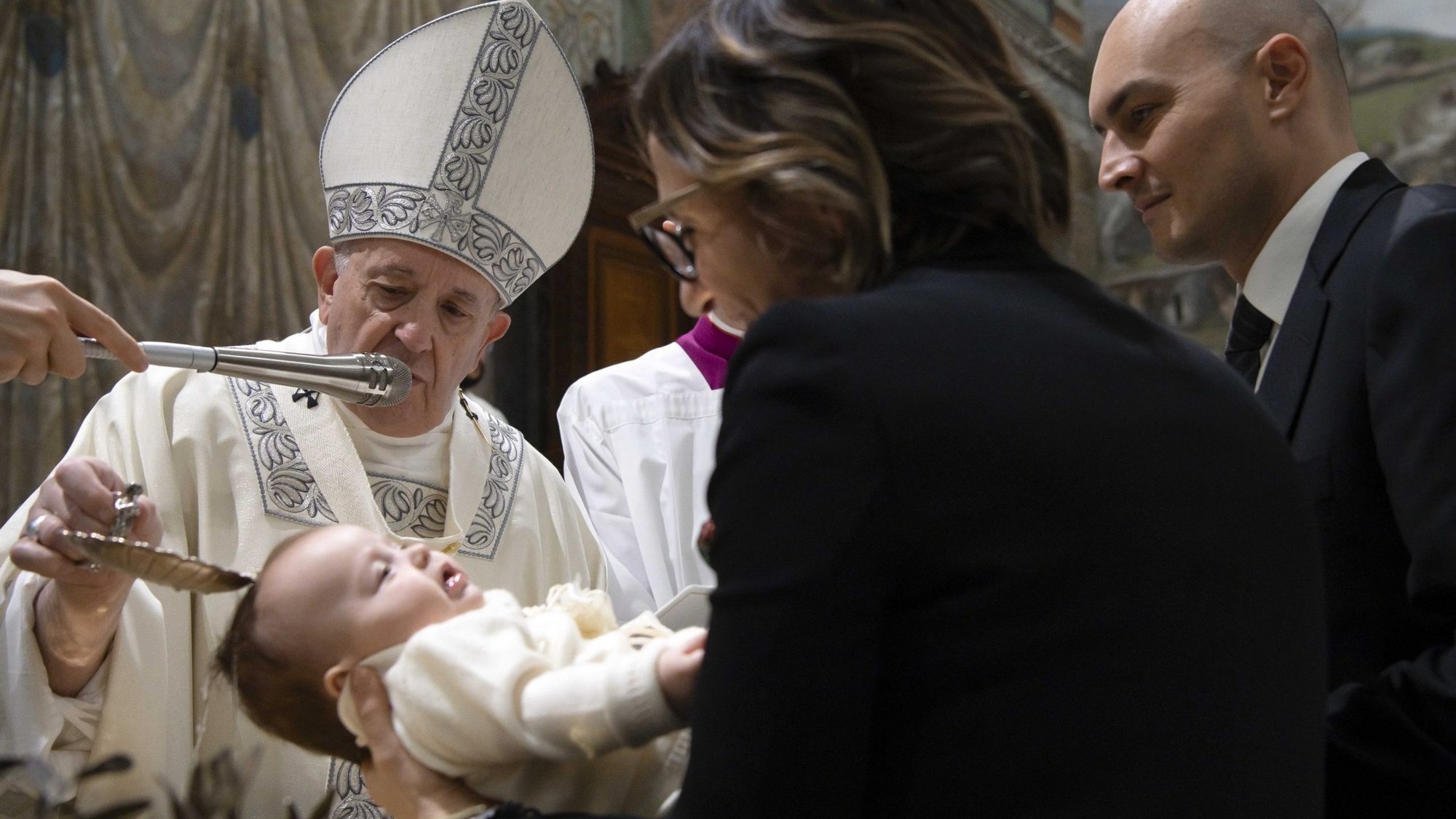 Pope Francis baptizes one of 32 babies as he celebrates Mass on the feast of the Baptism of the Lord in the Sistine Chapel at the Vatican Jan. 12, 2020. Because of the COVID-19 pandemic, Pope Francis will not baptize infants this year on the feast of the baptism of the Lord. (CNS photo/Vatican Media)