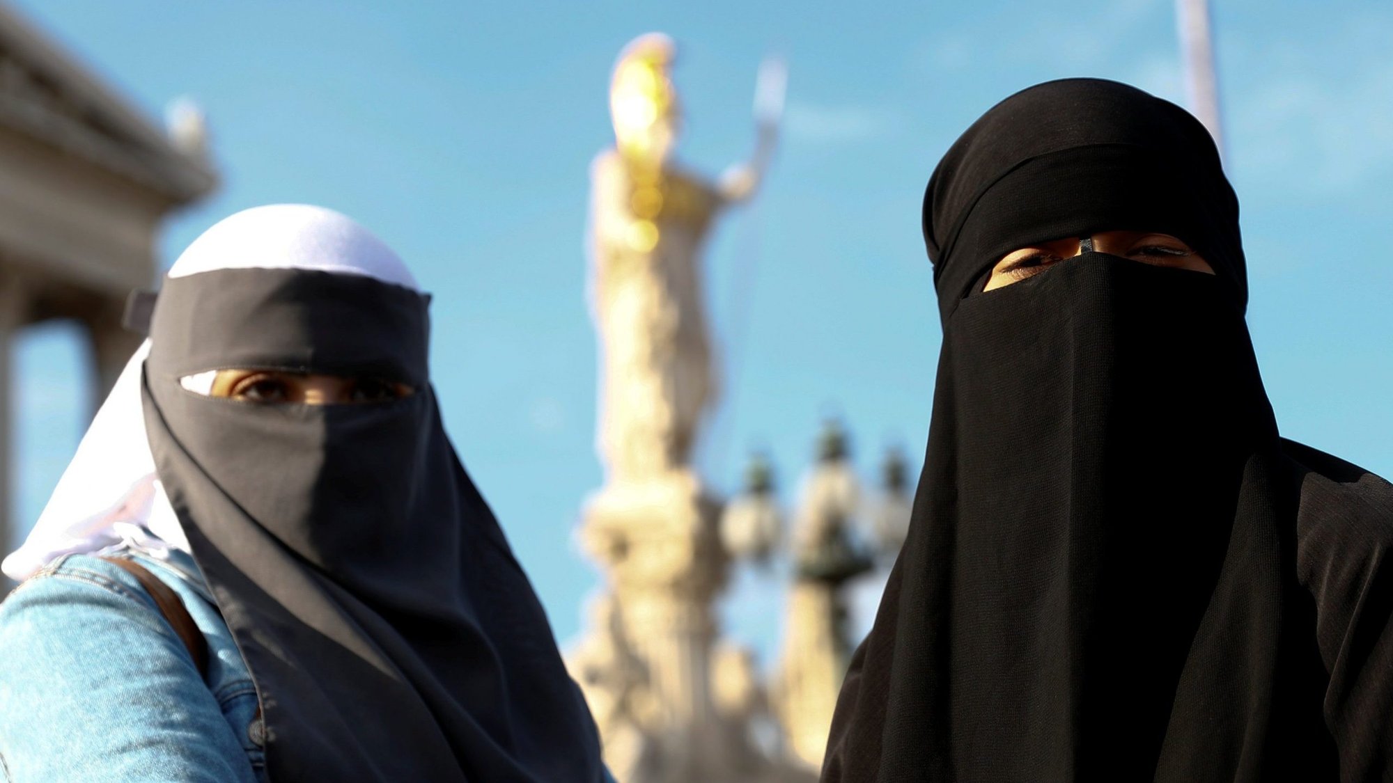 Demonstrators covering their faces participate in a protest called "The traditional clown's walk against the burqa ban" in Vienna Oct. 1, 2017. Swiss religious leaders say a proposed ban on Muslim head coverings would violate religious freedom. (CNS photo/Leonhard Foeger, Reuters)