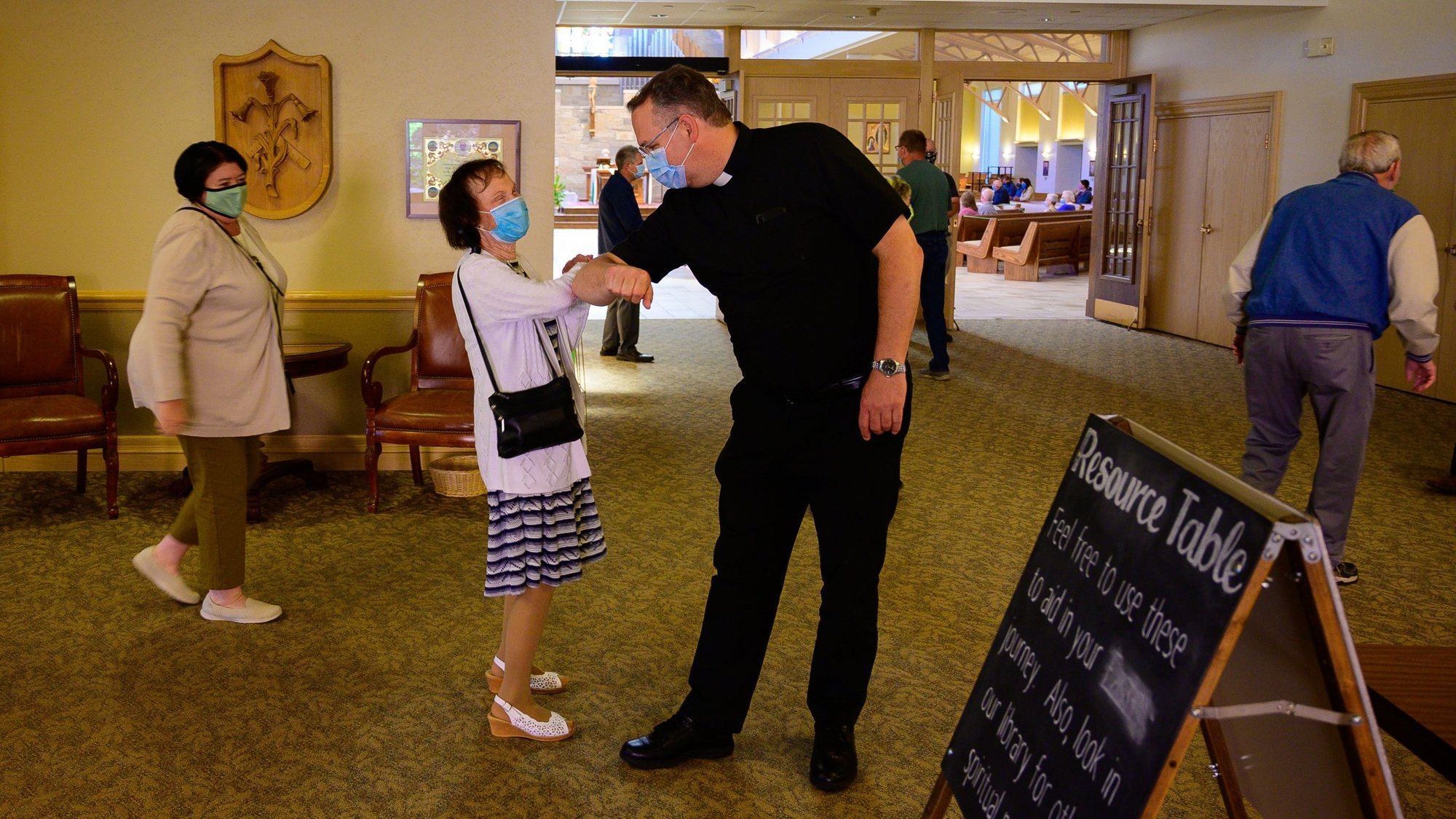 Father Peter Ambting, pastor of Our Lady of Lourdes Parish in De Pere, Wis., greets a parishioner before Mass in this June 14, 2020, file photo. Pope Francis, in his message for World Mission Sunday, said that during the pandemic there is an "urgent need for the mission of compassion." (CNS photo/Sam Lucero, The Compass)