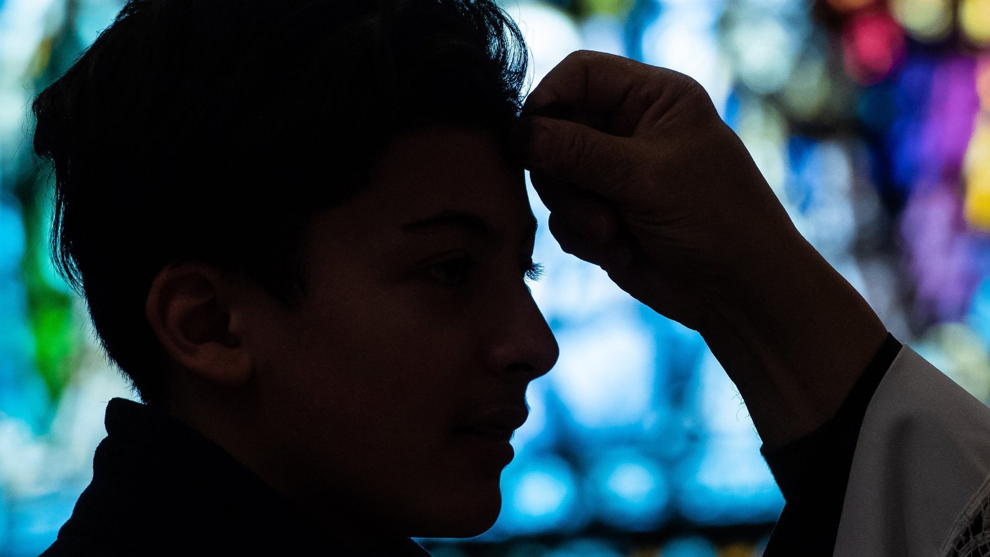 In this 2019 file photo, a young man receives ashes on his forehead during Ash Wednesday Mass at SS. Peter and Paul Church in Green Bay, Wis. The Vatican said priests can take special anti-COVID-19 precautions this year when distributing ashes on Ash Wednesday, Feb. 17, including sprinkling ashes on the top of people's heads rather than using them to make a cross on people's foreheads. (CNS photo/Sam Lucero, The Compass)