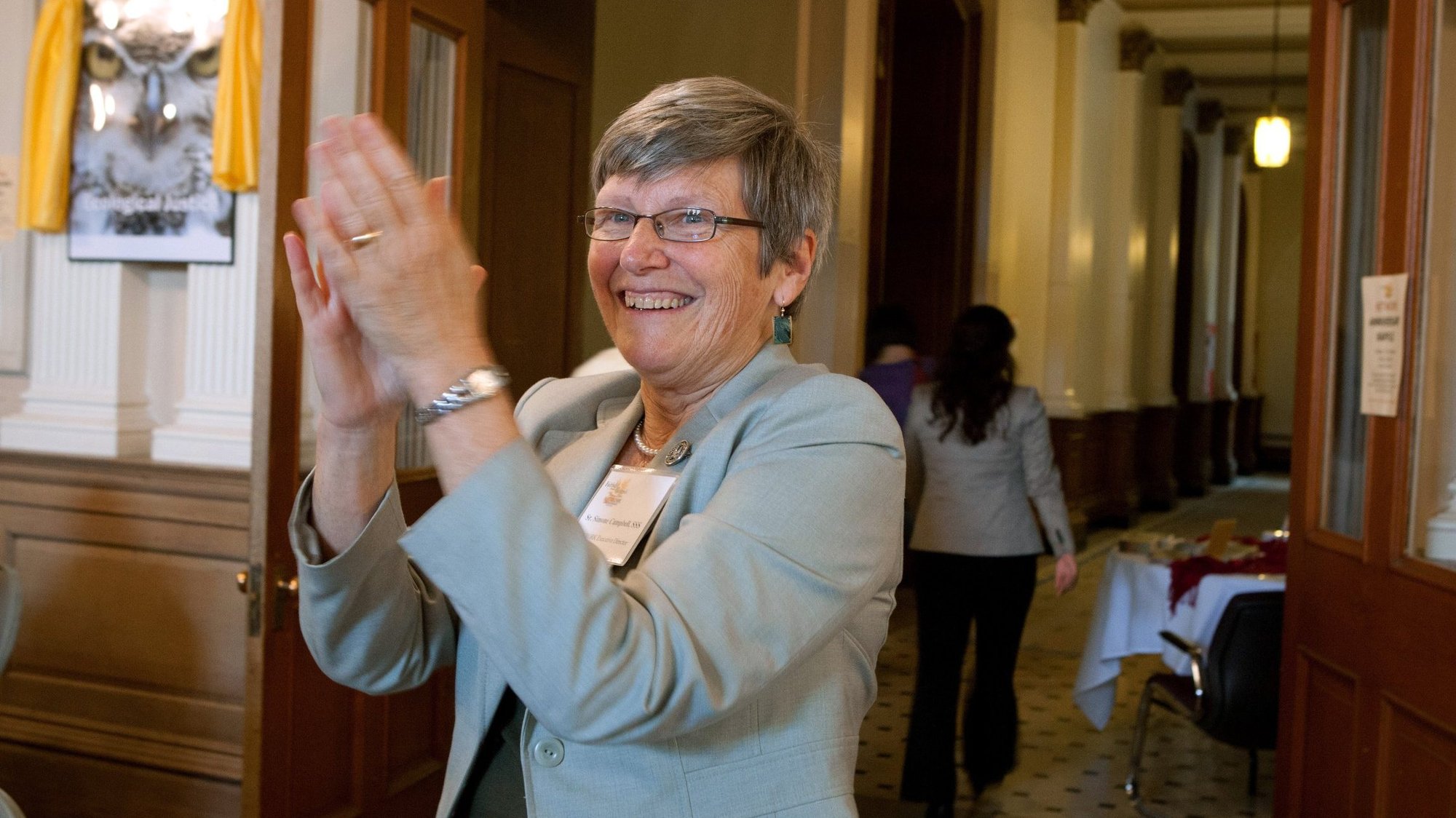 Sister Simone Campbell, a Sister of Social Service, who is executive director of Network, applauds during the group's 40th anniversary celebration at Trinity Washington University April 14, 2012. She will step down from Network in March 2021 after having headed the organization since 2004 and led it through a period of growth, rising nationwide visibility and wide recognition as a consistent voice for justice. (CNS photo/Nancy Phelan Wiechec)