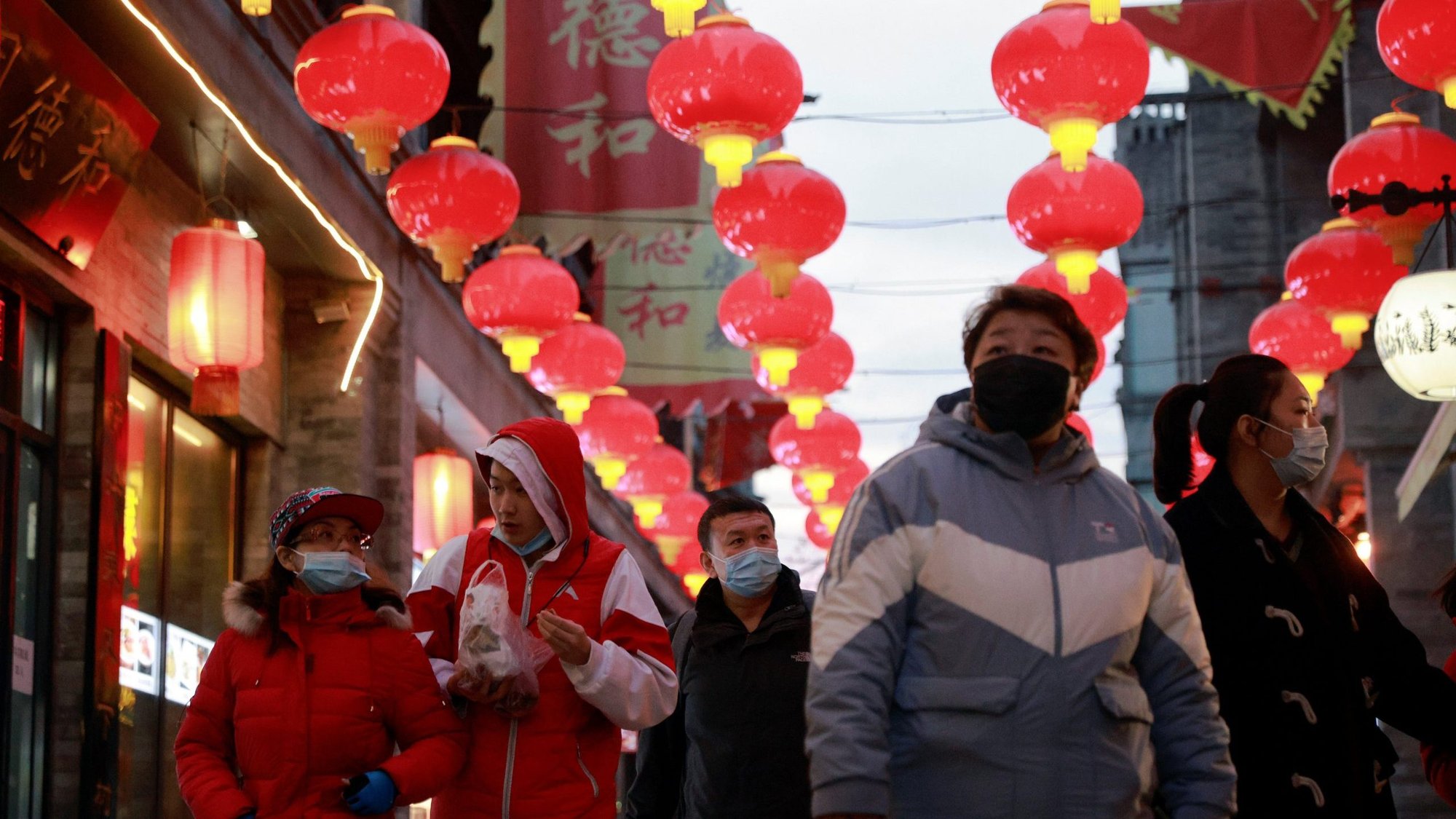 People walk in a historic Beijing street decorated for Lunar New Year celebrations during the coronavirus pandemic Feb. 8, 2021. Lunar New Year begins in China Feb. 12. (CNS photo/Thomas Peter, Reuters)