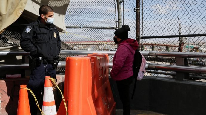 A migrant from Guatemala talks to a U.S. Customs and Border Protection agent at the Paso del Norte international border bridge in El Paso, Texas, Jan. 26, 2021, to request asylum. U.S. Catholic officials Feb. 10 called for Temporary Protected Status for Central Americans coming to the U.S. and foreign aid for their hurricane-devastated nations. (CNS photo/Jose Luis Gonzalez via Crux)