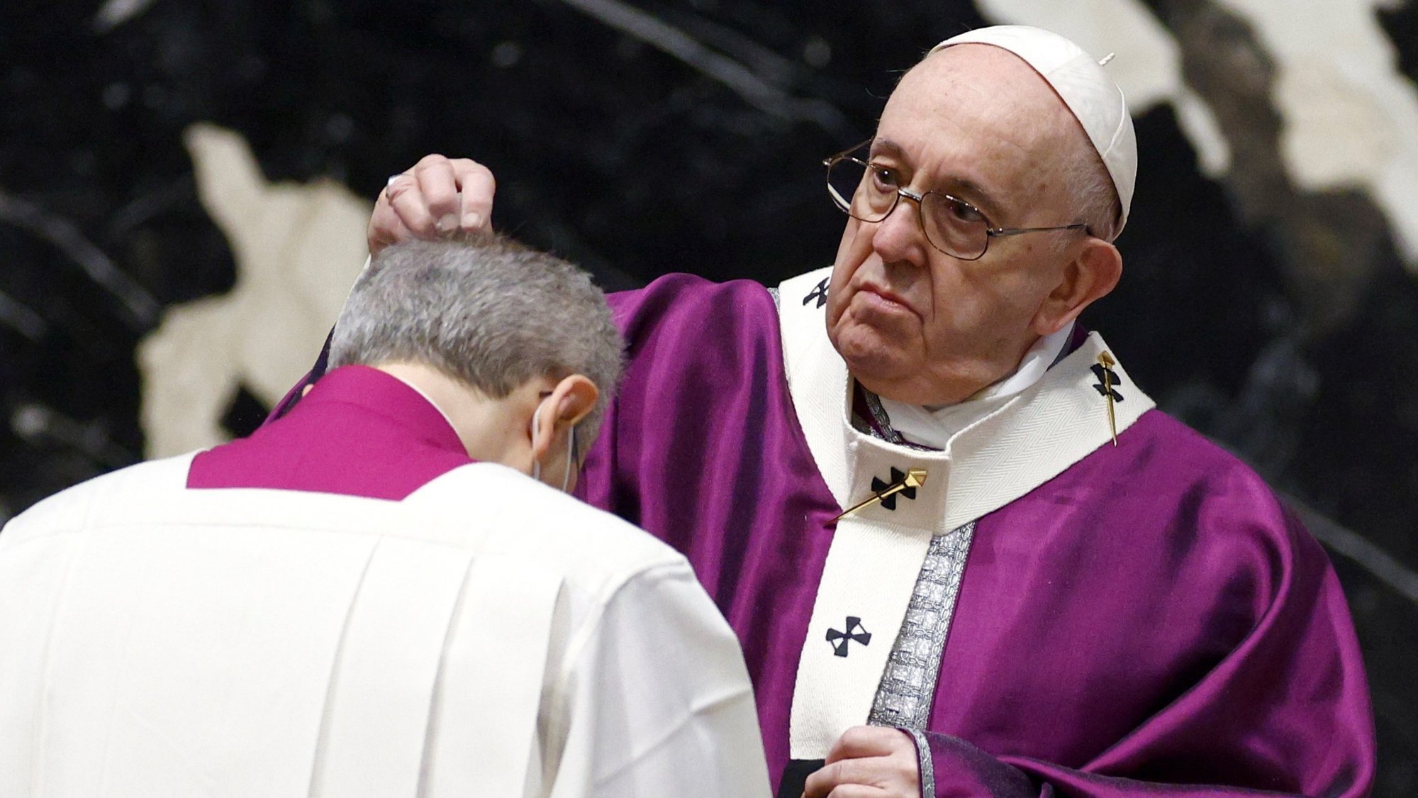 Pope Francis sprinkles ashes on the head of a priest during Ash Wednesday Mass in St. Peter's Basilica at the Vatican Feb. 17, 2021. (CNS photo/Guglielmo Mangiapane, Reuters)