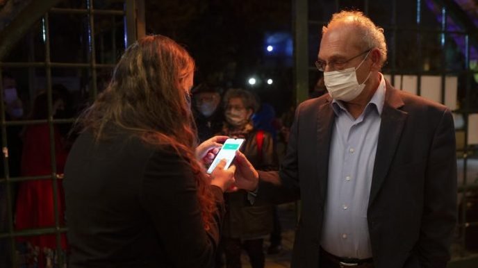 A man presents his "green passport," proof that he is vaccinated against the coronavirus, on opening night at the Khan Theater for a performance where all guests were required to show proof of vaccination or full recovery from the virus, in Jerusalem, Tuesday, Feb. 23, 2021. (Maya Alleruzzo/AP via Crux)