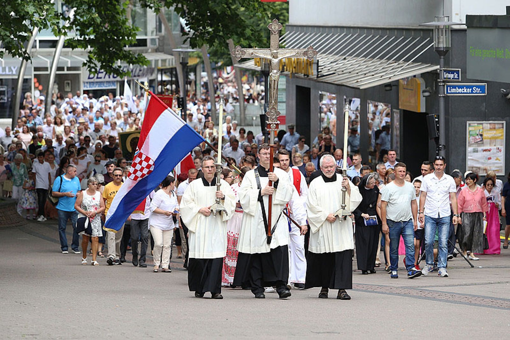 The May 31, 2018 Corpus Christi procession stops at the central Protestant church in Essen, Germany. During the procession Bishop Franz-Josef Overbeck of Essen offered support for allowing a Protestant married to a Catholic to receive Communion as a sign of Christian unity. (CNS photo/Nicole Cronauge, courtesy Diocese of Essen)
