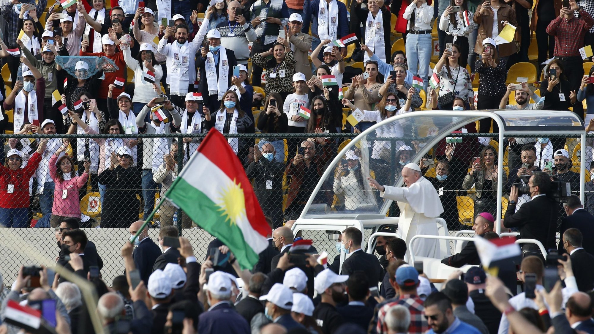 The flag of Kurdistan is seen as Pope Francis greets the crowd before celebrating Mass at Franso Hariri Stadium in Irbil, Iraq, March 7, 2021. (CNS photo/Paul Haring)