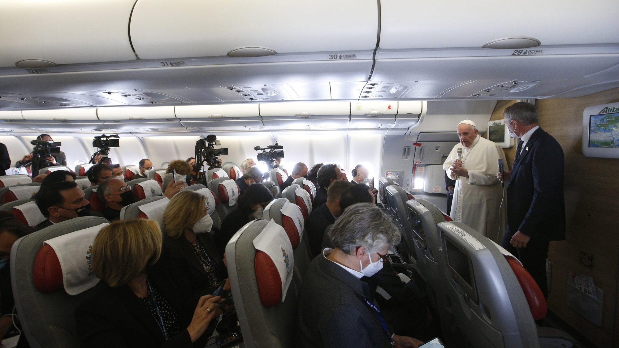 Pope Francis speaks with journalists aboard his flight from Baghdad to Rome March 8, 2021. (CNS photo/Paul Haring)