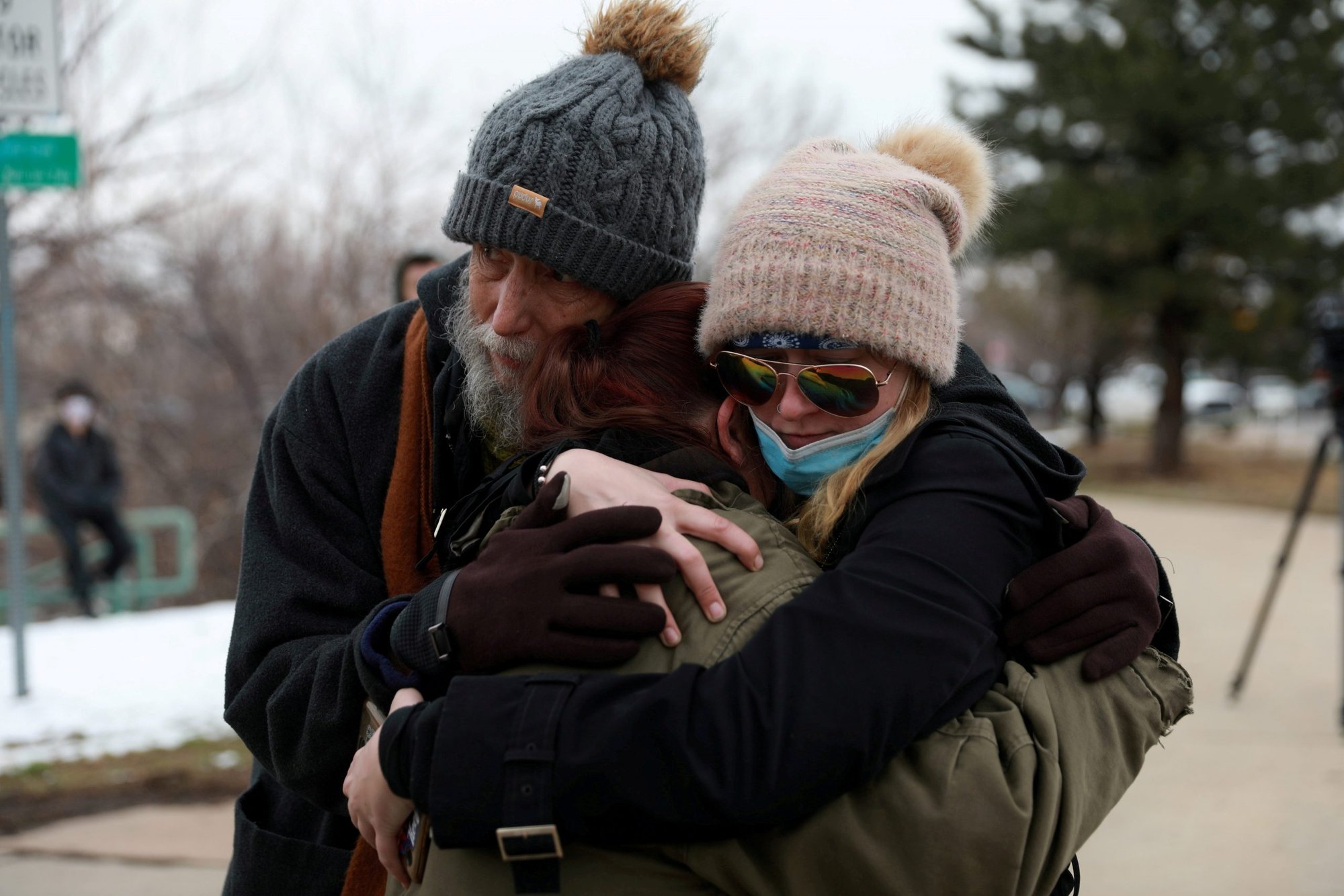 David and Maggie Prowell comfort Sarah Moonshadow outside King Soopers supermarket in Boulder, Colo., March 22, 2021. Moonshadow was inside the grocery store while a gunman killed 10 people. (CNS photo/Alyson McClaran, Reuters)