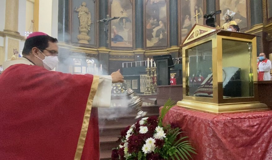 Salvadoran Archbishop Jose Luis Escobar Alas of San Salvador incenses a relic, the miter of St. Oscar Romero, March 24, 2021, at the cathedral in San Salvador. (CNS photo/Rhina Guidos)