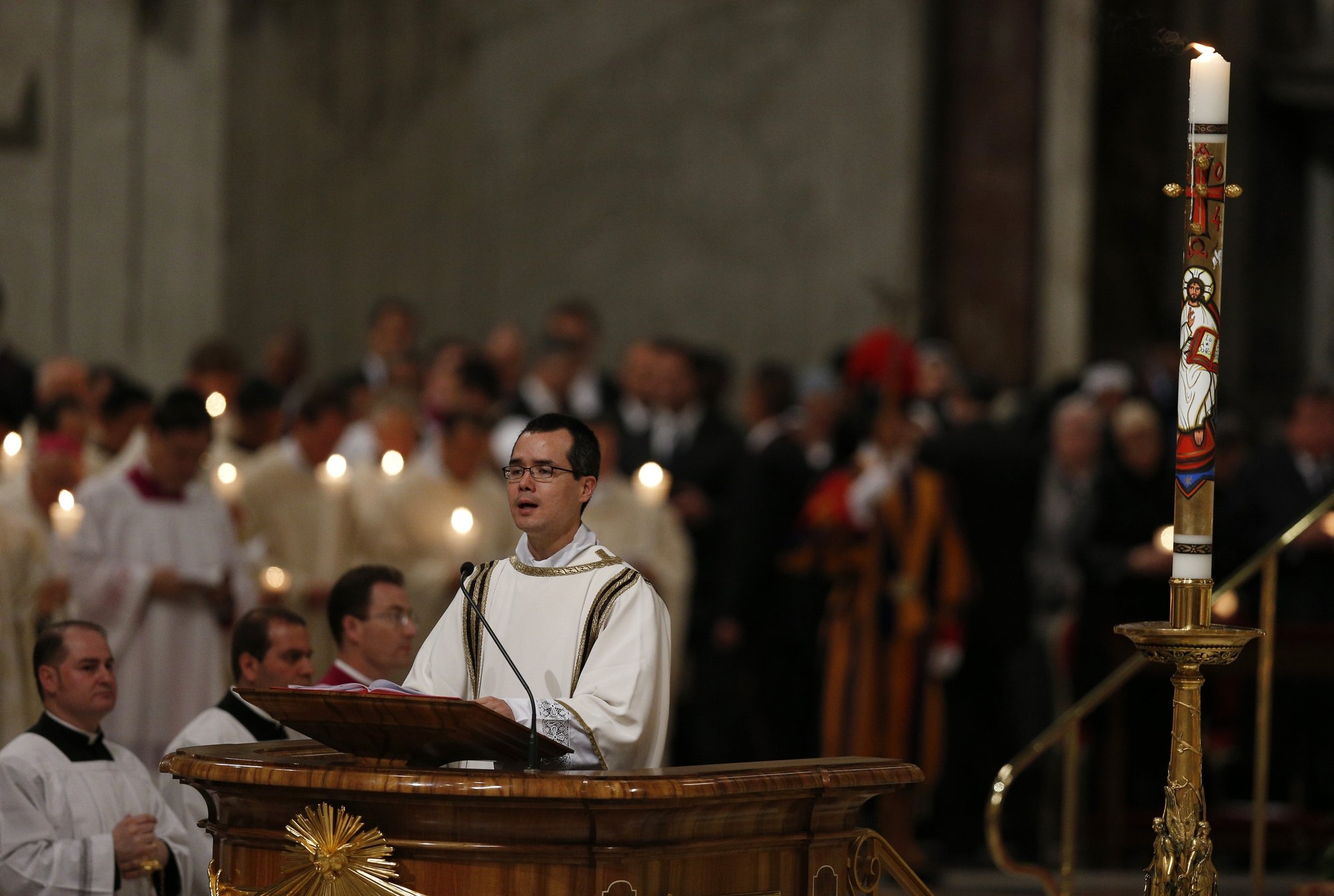 Then-Deacon Brian Baker from the Archdiocese of Atlanta chants the Exultet at the beginning of the 2014 Easter Vigil celebrated by Pope Francis in St. Peter's Basilica. (CNS/Paul Haring)