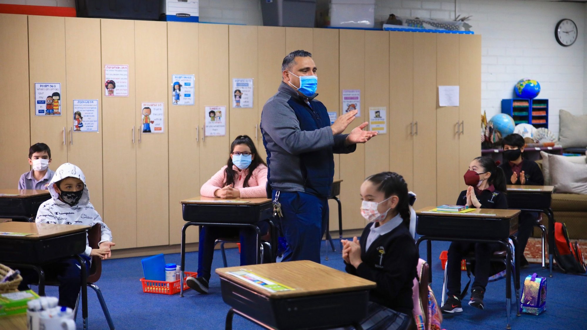 Principal Aaron De Loera talks to 3rd grade students on the first day of in-person class at St. Bernard Catholic School in Bellflower on March 3, 2021. (David Amador Rivera)