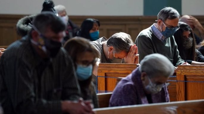 Worshippers pray during a bilingual memorial Mass March 13, 2021, for parishioners who have died from COVID-19 at St. John-Visitation Church in the Bronx borough of New York. Many members of the parish community were infected by the coronavirus, including over 50 who succumbed to it. (Gregory A. Shemitz/CNS).