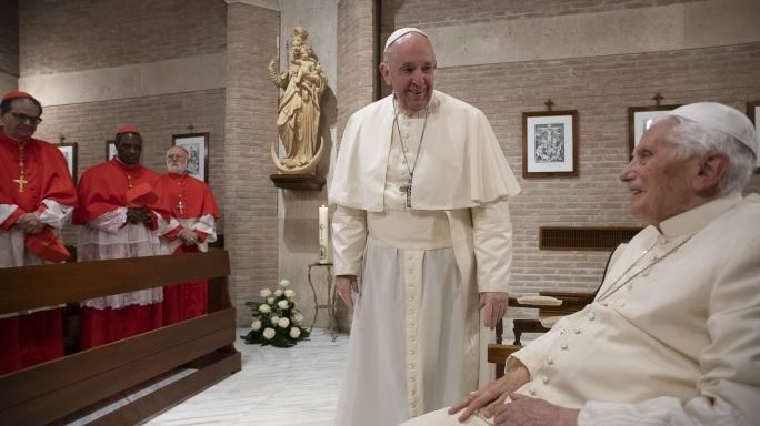In this file photo, Pope Francis with Pope Emeritus Benedict XVI as he pays him a visit after the Consistory, with the newly elevated Cardinals, at the Vatican, Saturday, Nov. 28, 2020. (Vatican Media/AP via Crux)