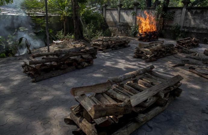 The body of a person who died of COVID-19 is cremated in Gauhati, India, Tuesday, April 27, 2021. The COVID-19 death toll in India has topped 200,000. (Anupam Nath/AP)
