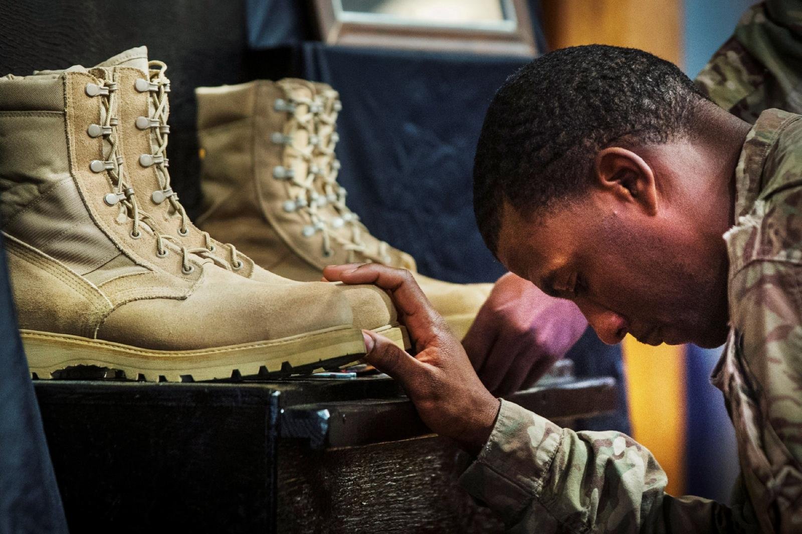 A U.S. soldier from the 3rd Cavalry Regiment pays his respects during a memorial for Spc. Wyatt Martin and Sgt. First Class Ramon Morris at Bagram Air Field in Afghanistan in this Dec. 23, 2014 file photo. U.S. President Joe Biden announced a complete withdrawal of U.S. troops in Afghanistan by Sept. 11, 2021. (CNS photo/Lucas Jackson, Reuters)