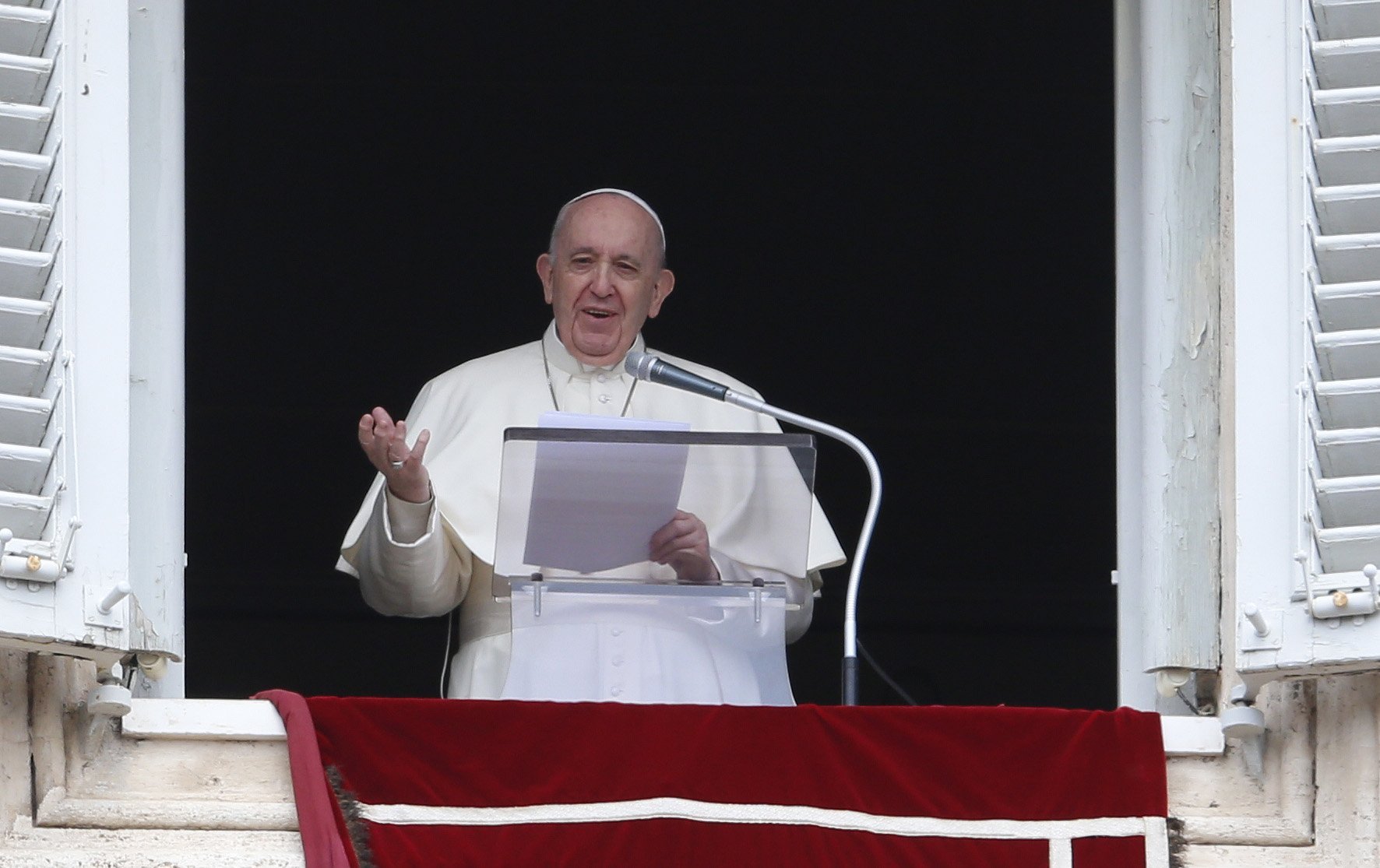 Pope Francis greets the crowd as he leads the "Regina Coeli" from the window of his studio overlooking St. Peter's Square at the Vatican April 18, 2021. (CNS photo/Paul Haring)