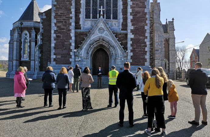 Catholics stand outside Sts. Anne and Mary Cathedral in Cork, Ireland, April 4, 2021, praying that it would be open for Easter Mass during the COVID-19 pandemic. Churches in the Irish Republic have been closed for public worship since Dec. 26, but on April 16, the health minister made it a crime to celebrate or attend a public Mass. (Cillian Kelly/CNS)