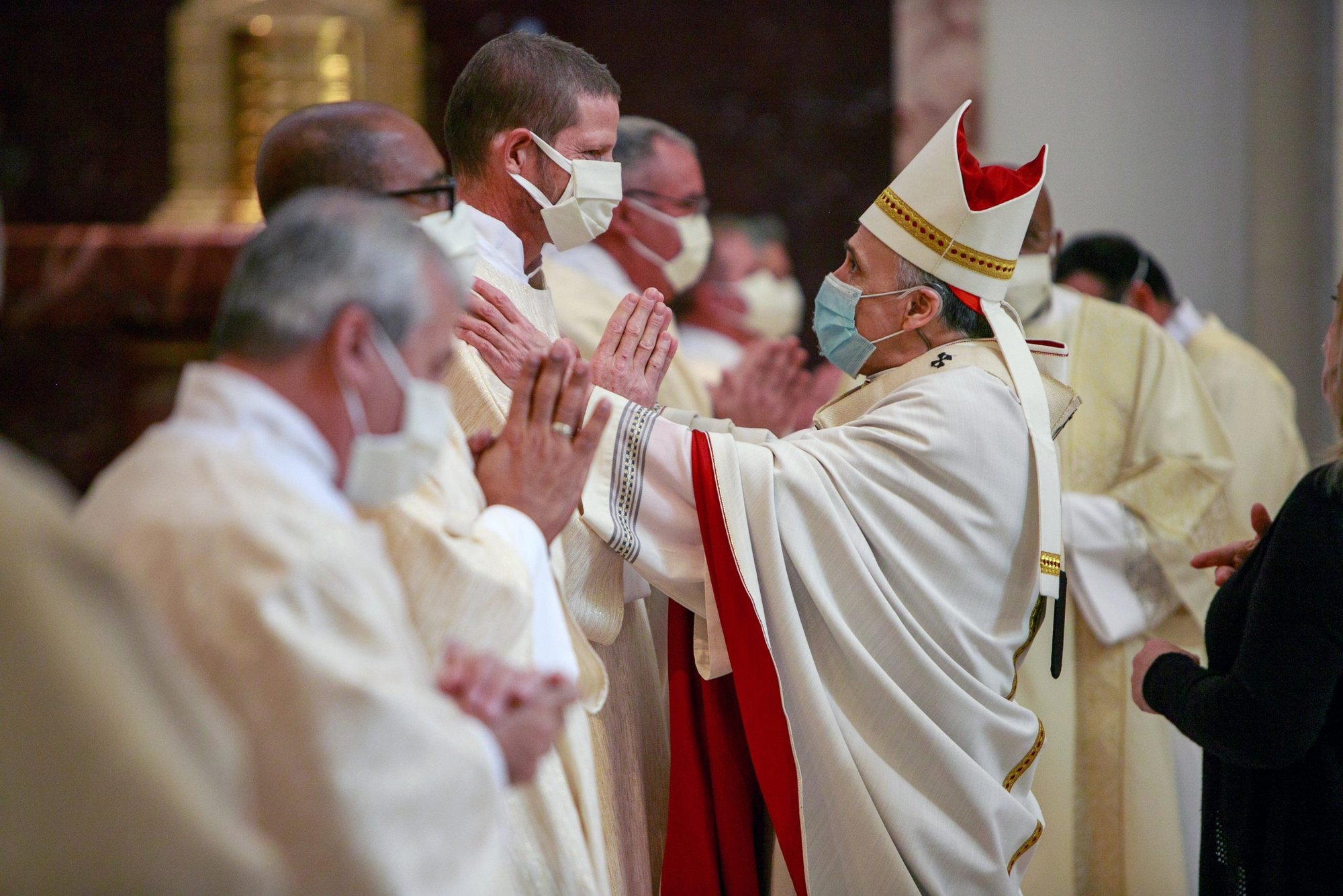 Cardinal Daniel N. DiNardo of Galveston-Houston greets newly ordained Deacon Bruce Flagg during a permanent diaconate ordination Mass at the Co-Cathedral of the Sacred Heart in Houston on Feb. 20, 2021. Deacon Flagg, who is deaf, assists with deaf ministry in the Archdiocese of Galveston-Houston. (CNS photo/James Ramos, Texas Catholic Herald)