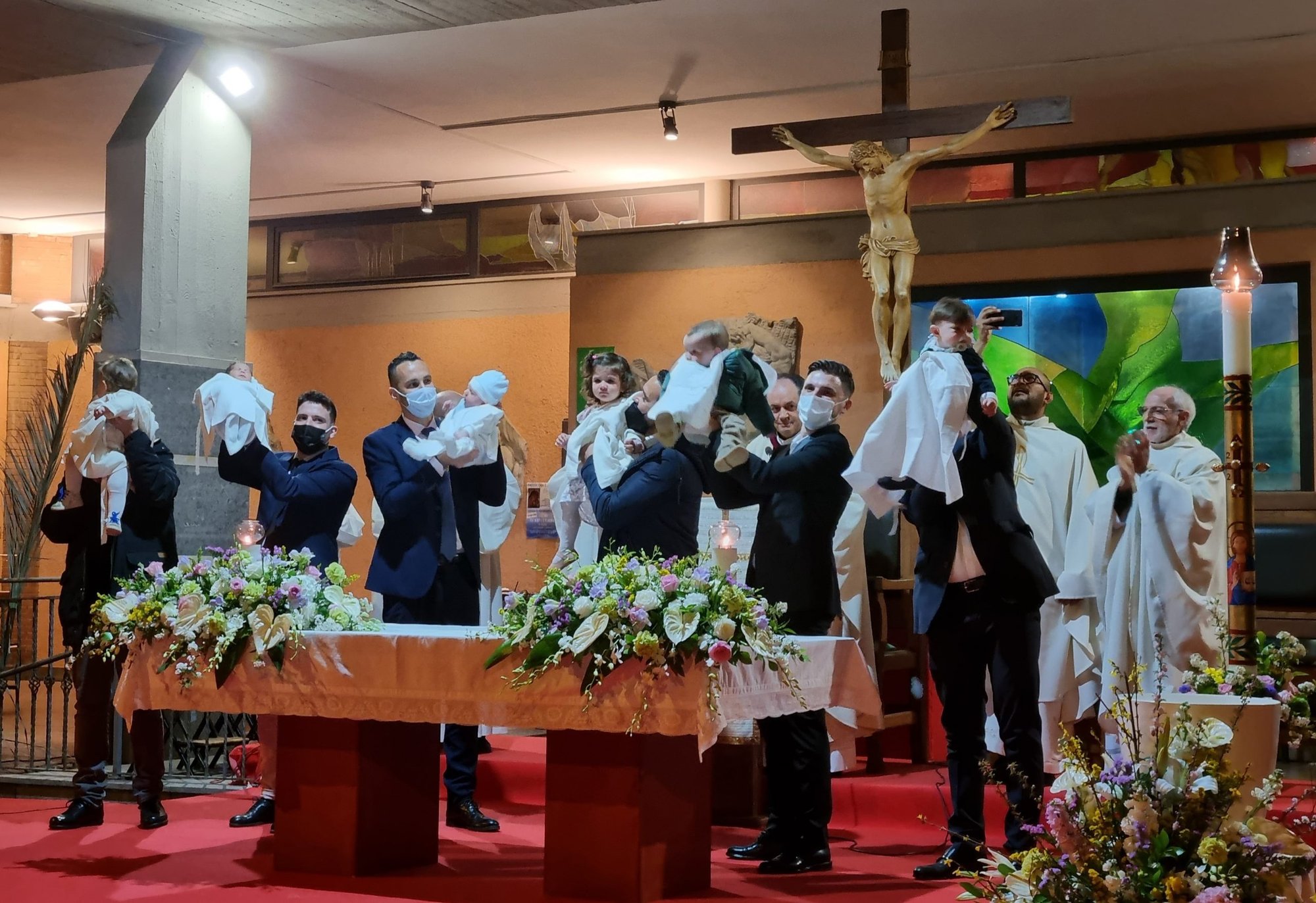Fathers present their newly baptized children during the Easter Vigil at San Timoteo Church in Rome, among them Valentina Pietropaolo’s son Diego (third from left).