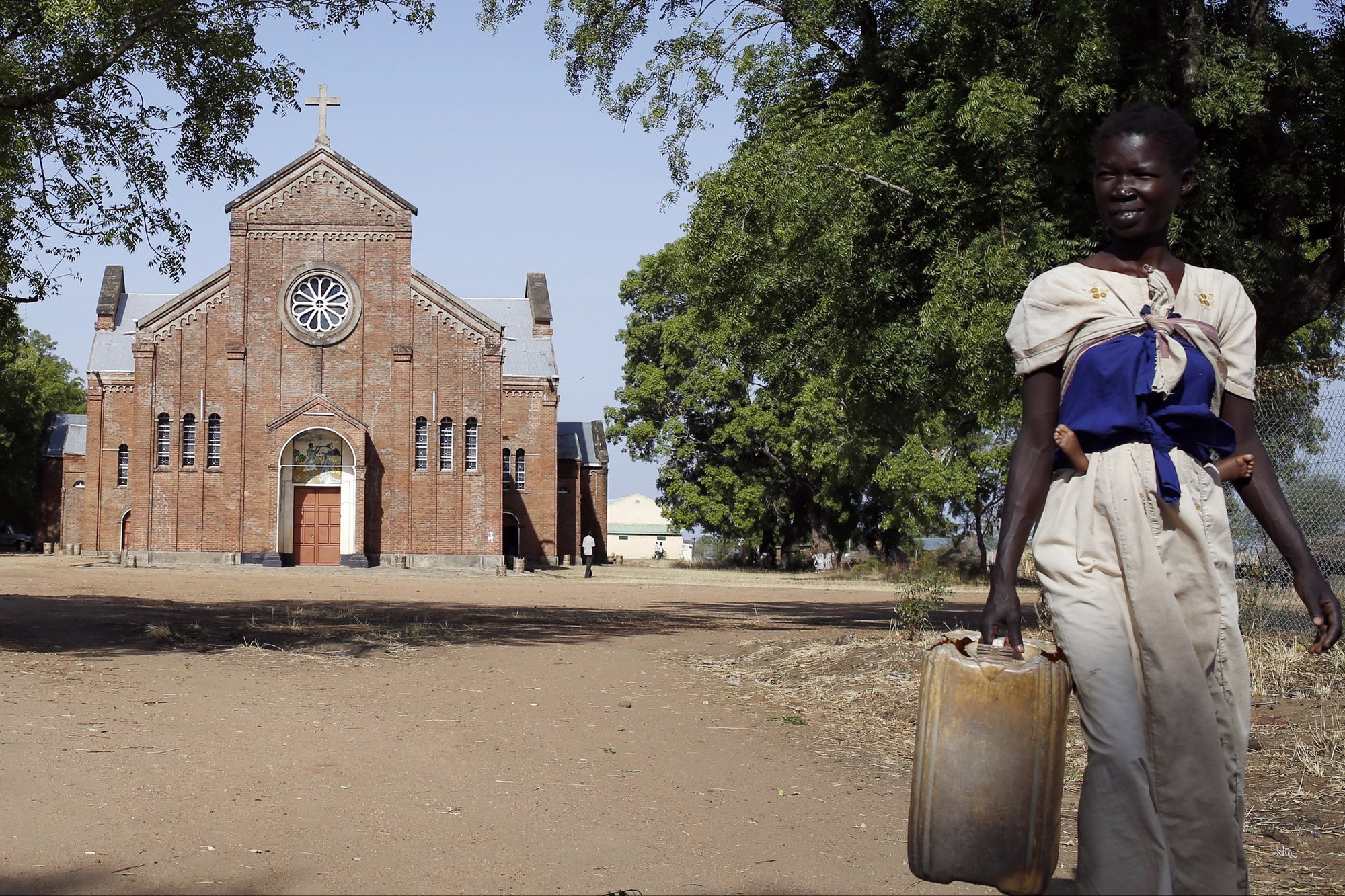 A young woman outside a church in Rajaf, South Sudan. (CNS/Matthieu Alexandre, Caritas Internationalis)